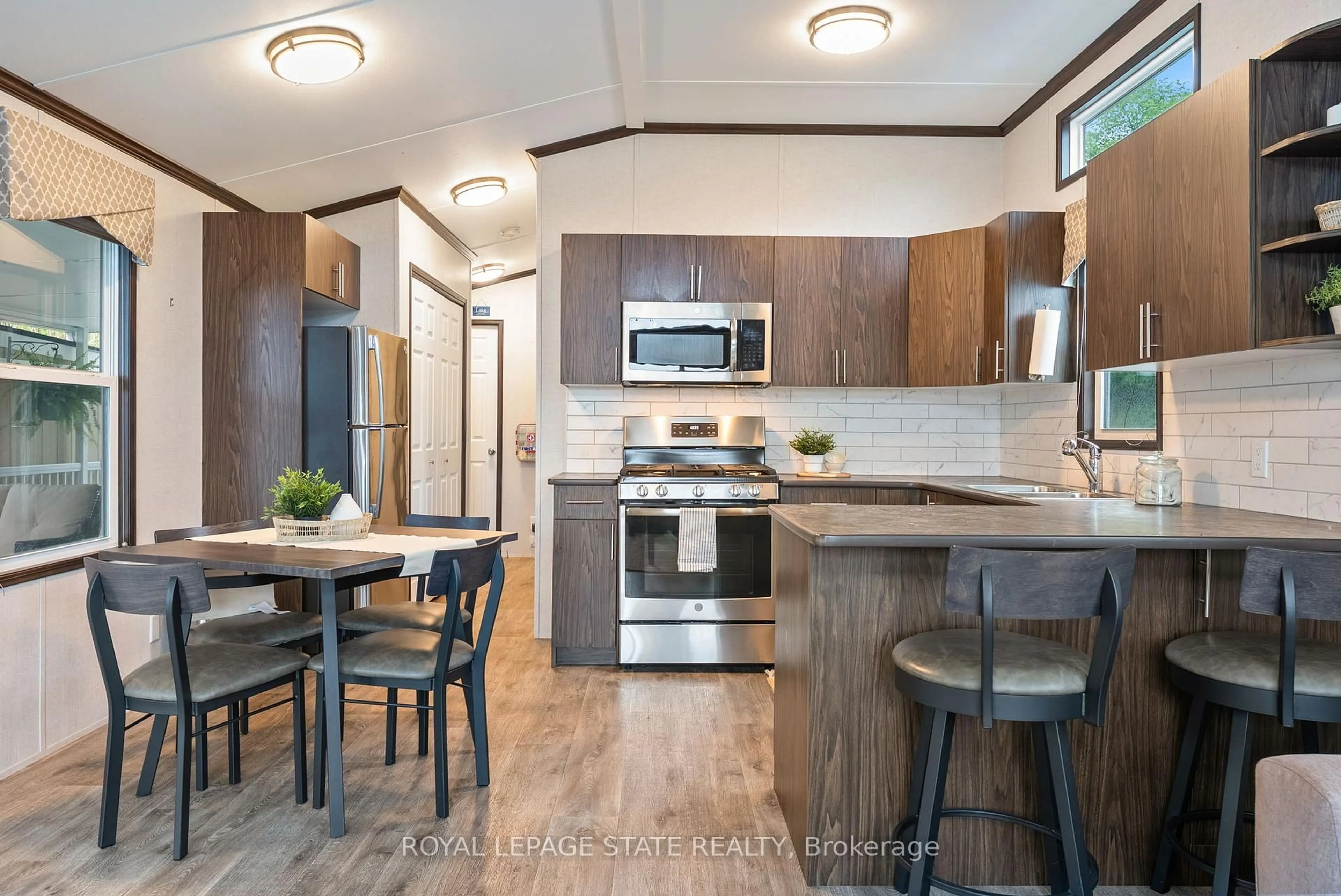 Open concept kitchen, wood/laminate floor for 490 Empire Rd #213, Port Colborne Ontario L0S 1R0