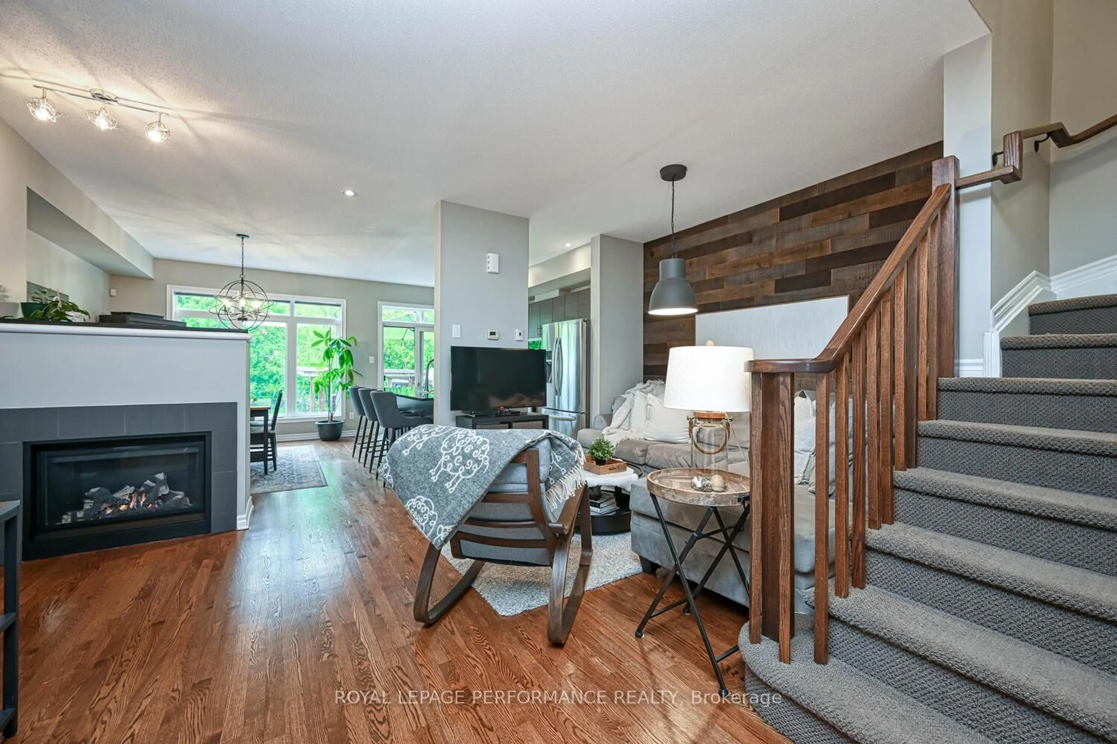 Living room with furniture, wood/laminate floor for 664 Whitecliffs Ave, Ottawa Ontario K1V 2N4