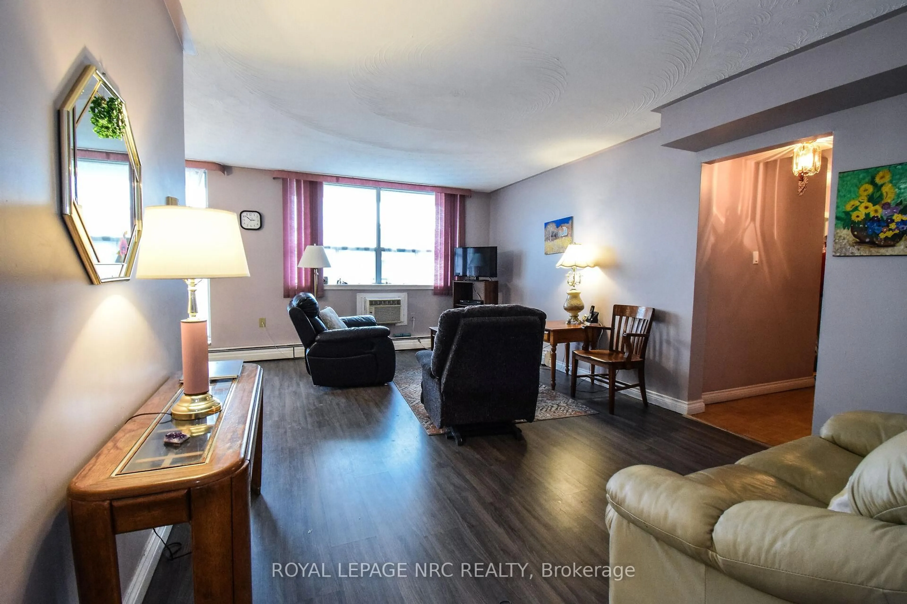 Living room with furniture, wood/laminate floor for 359 Geneva St #904, St. Catharines Ontario L2N 2G5