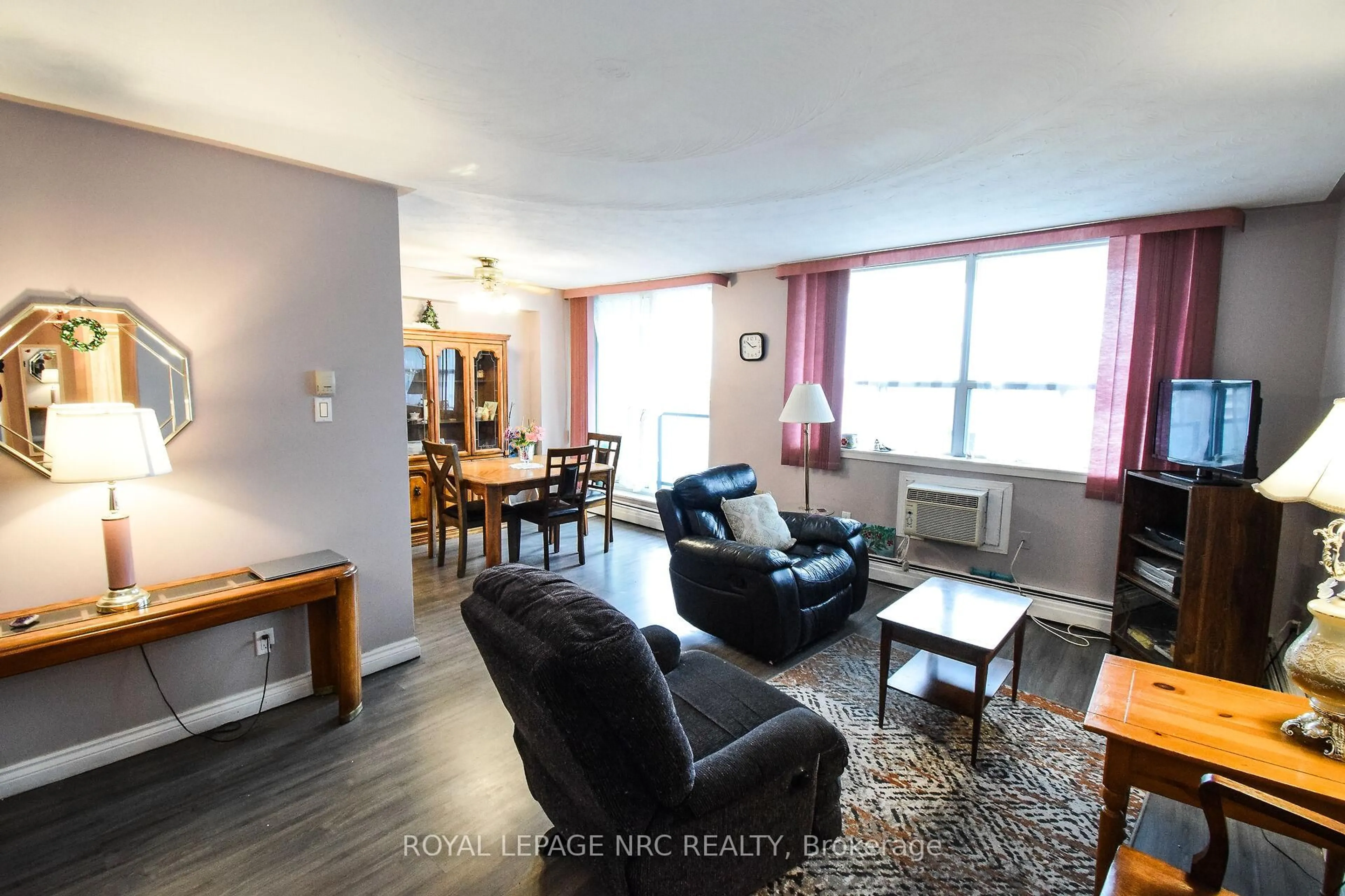 Living room with furniture, wood/laminate floor for 359 Geneva St #904, St. Catharines Ontario L2N 2G5