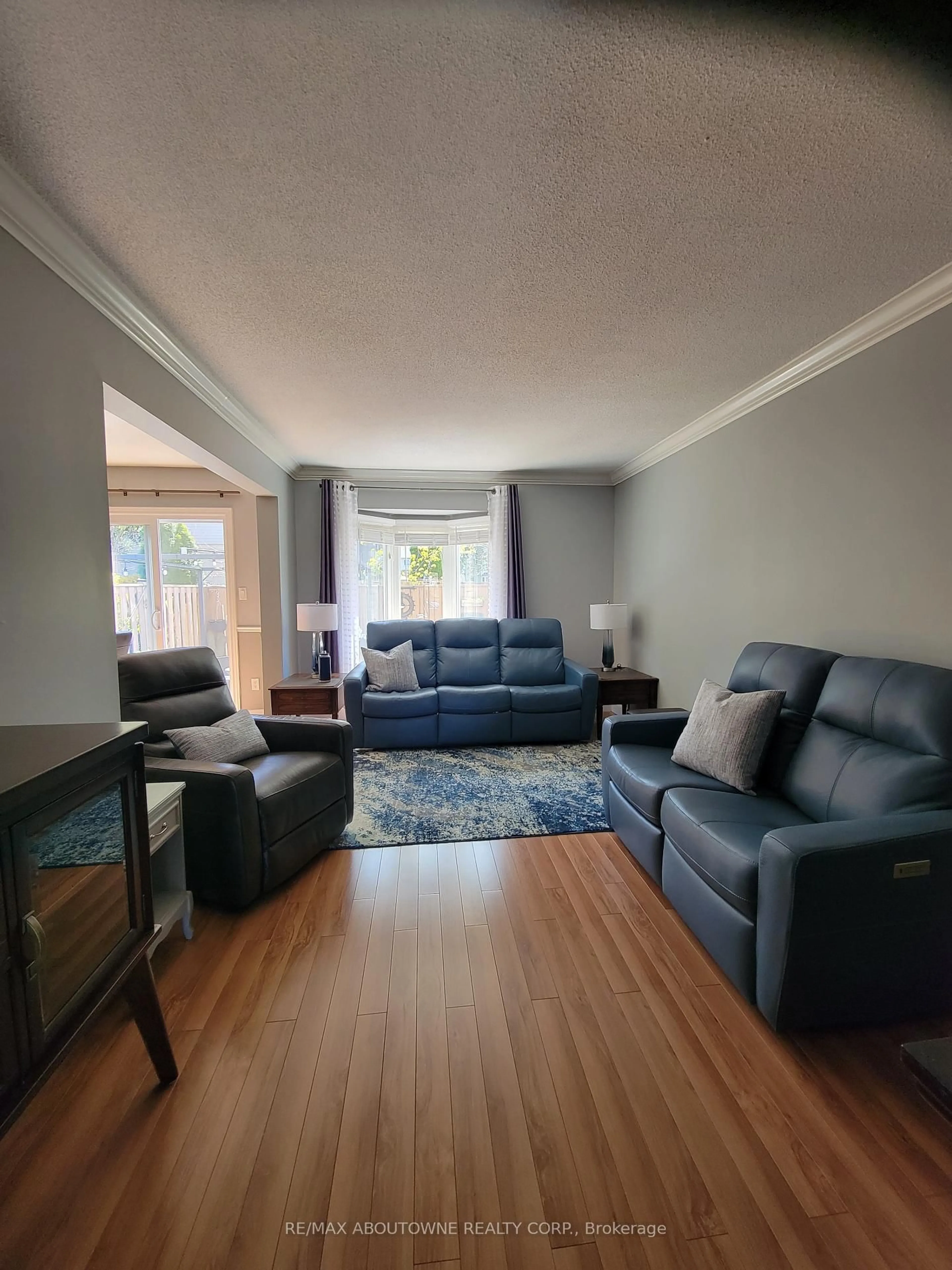 Living room with furniture, wood/laminate floor for 1 Royalwood Crt #44, Hamilton Ontario L8E 4Y3