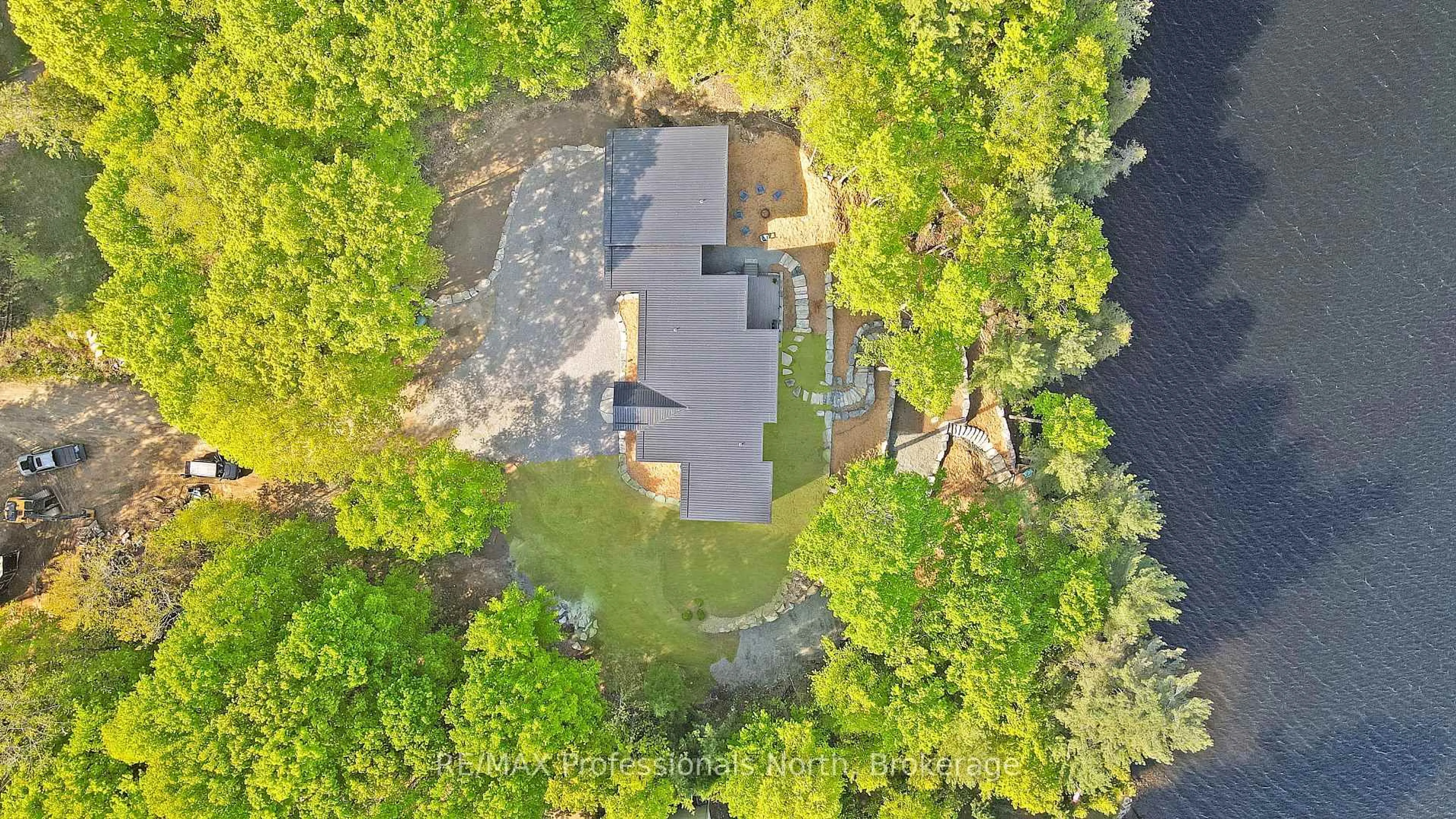 A pic from outside/outdoor area/front of a property/back of a property/a pic from drone, water/lake/river/ocean view for 1041 Minaki Lane, Minden Hills Ontario K0M 2K0