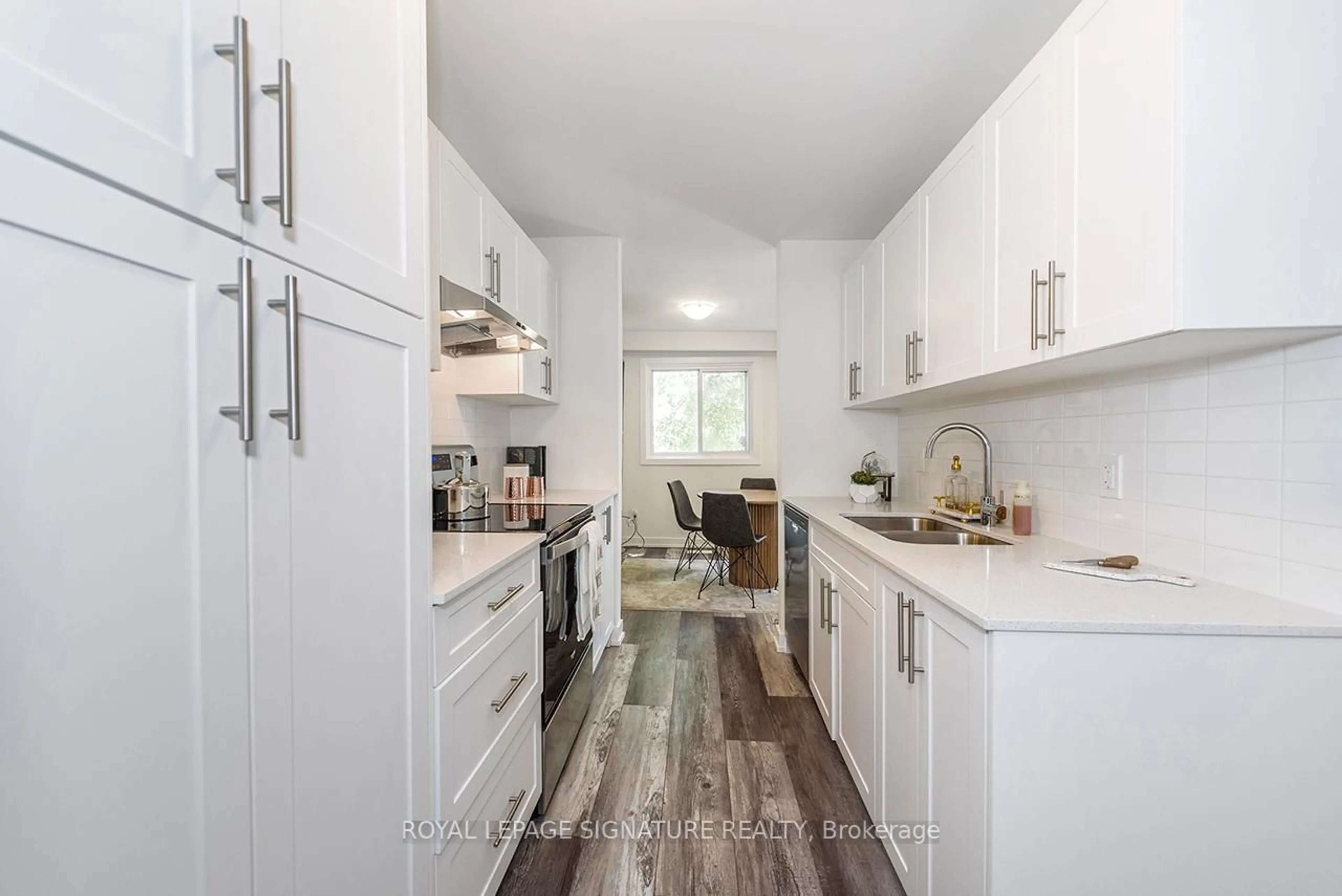 Open concept kitchen, wood/laminate floor for 1444 Upper Ottawa St #18, Hamilton Ontario L8W 1L3