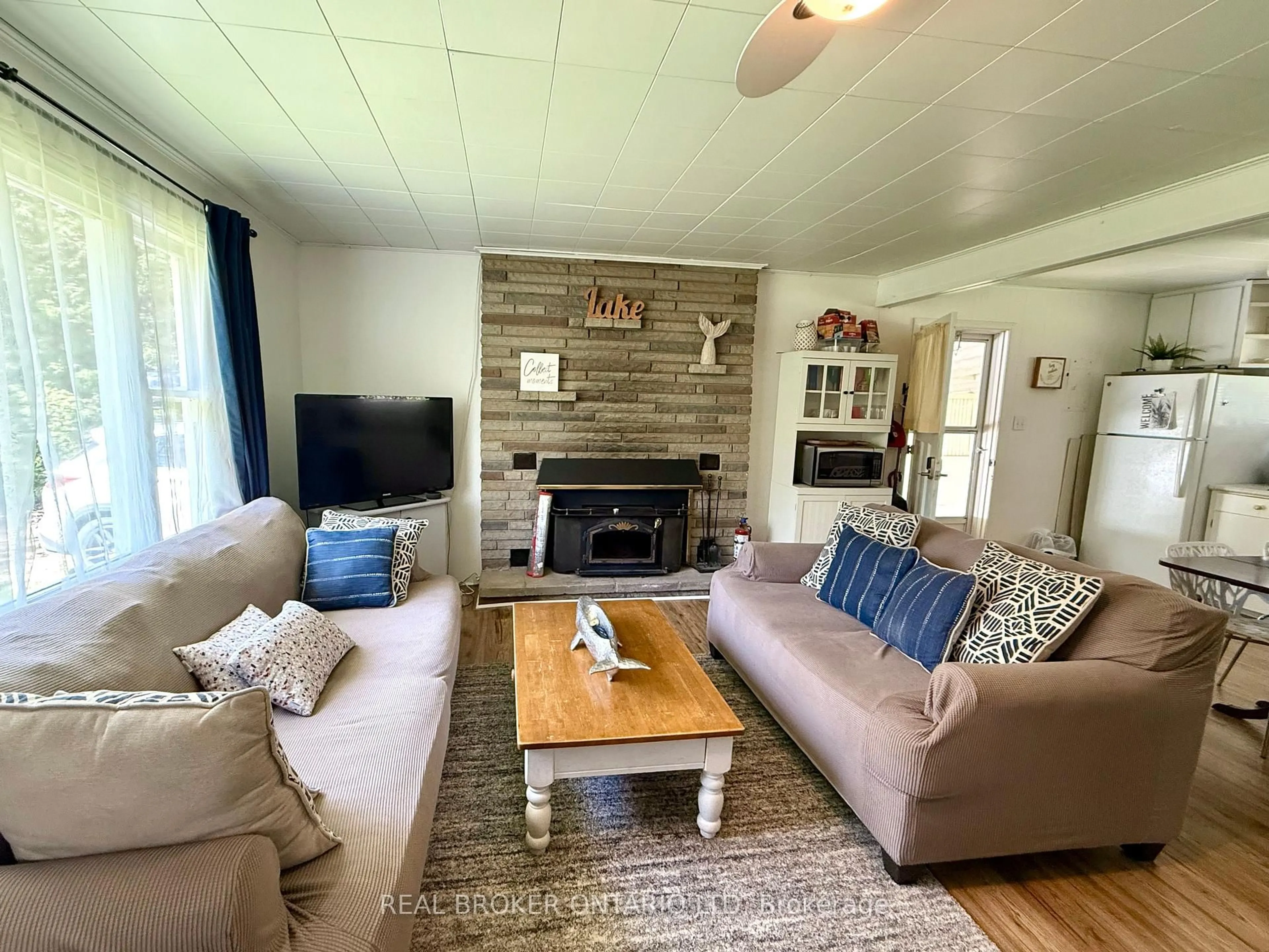 Living room with furniture, wood/laminate floor for 9684 Maylard Ave, Lambton Shores Ontario N0N 1J3