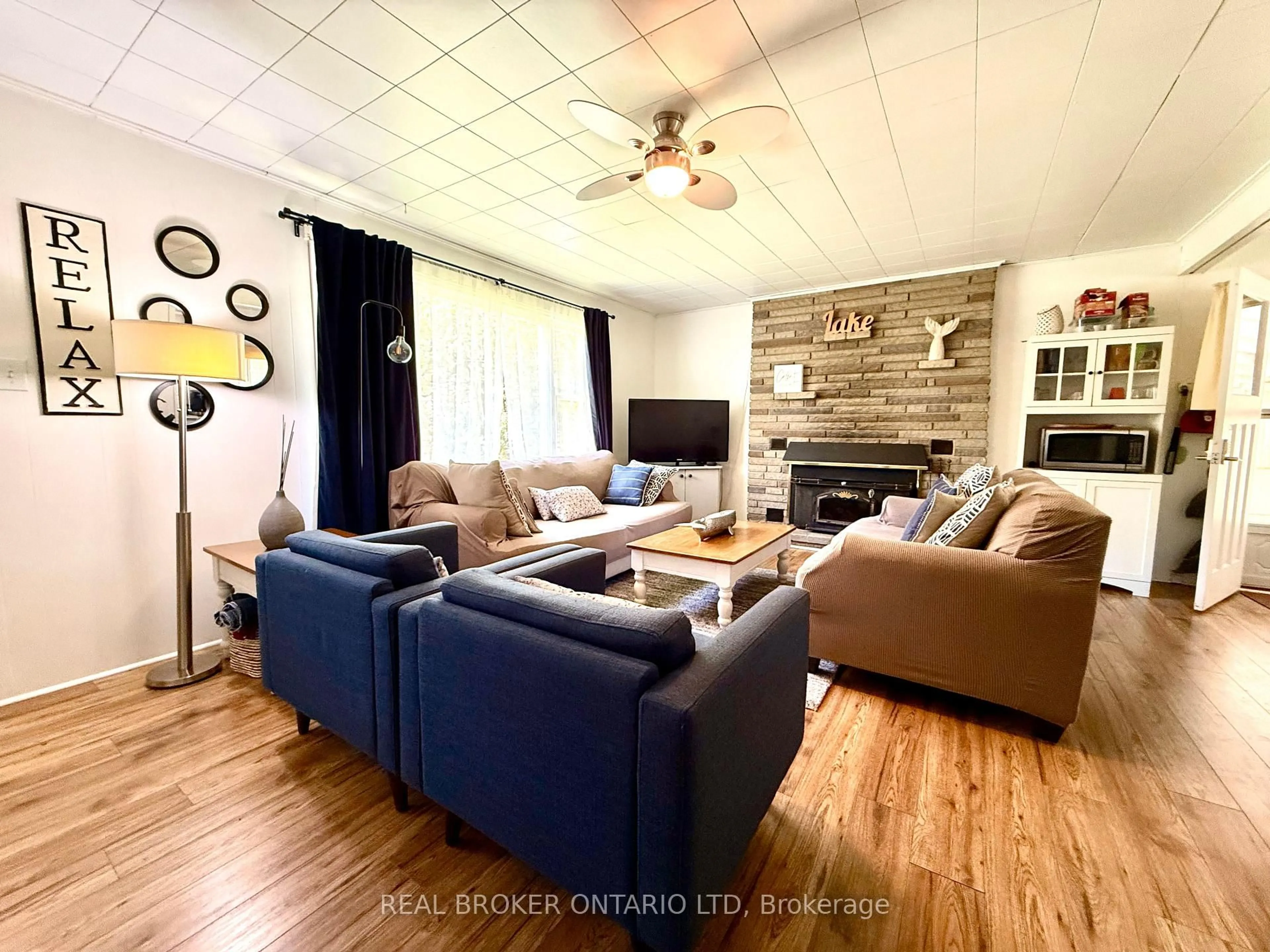 Living room with furniture, wood/laminate floor for 9684 Maylard Ave, Lambton Shores Ontario N0N 1J3