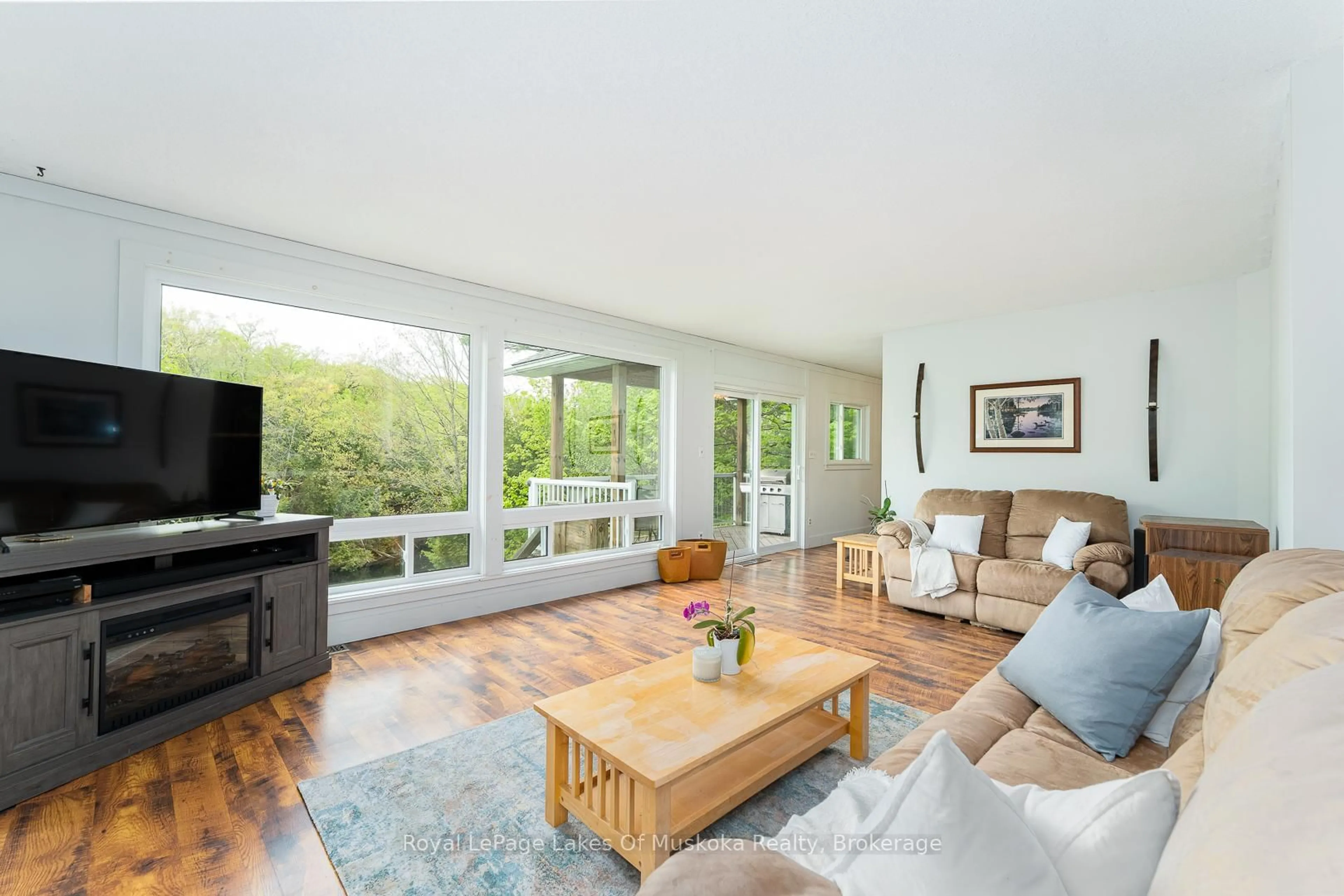 Living room with furniture, wood/laminate floor for 1075 Rocky Narrows Rd, Bracebridge Ontario P1L 1X1