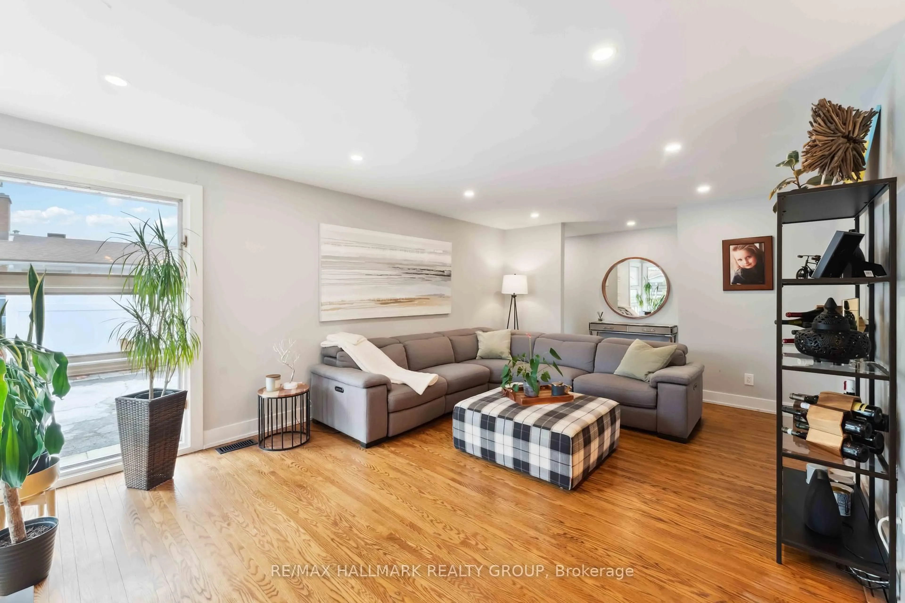 Living room with furniture, wood/laminate floor for 2425 Ogilvie Rd, Ottawa Ontario K1J 7N3
