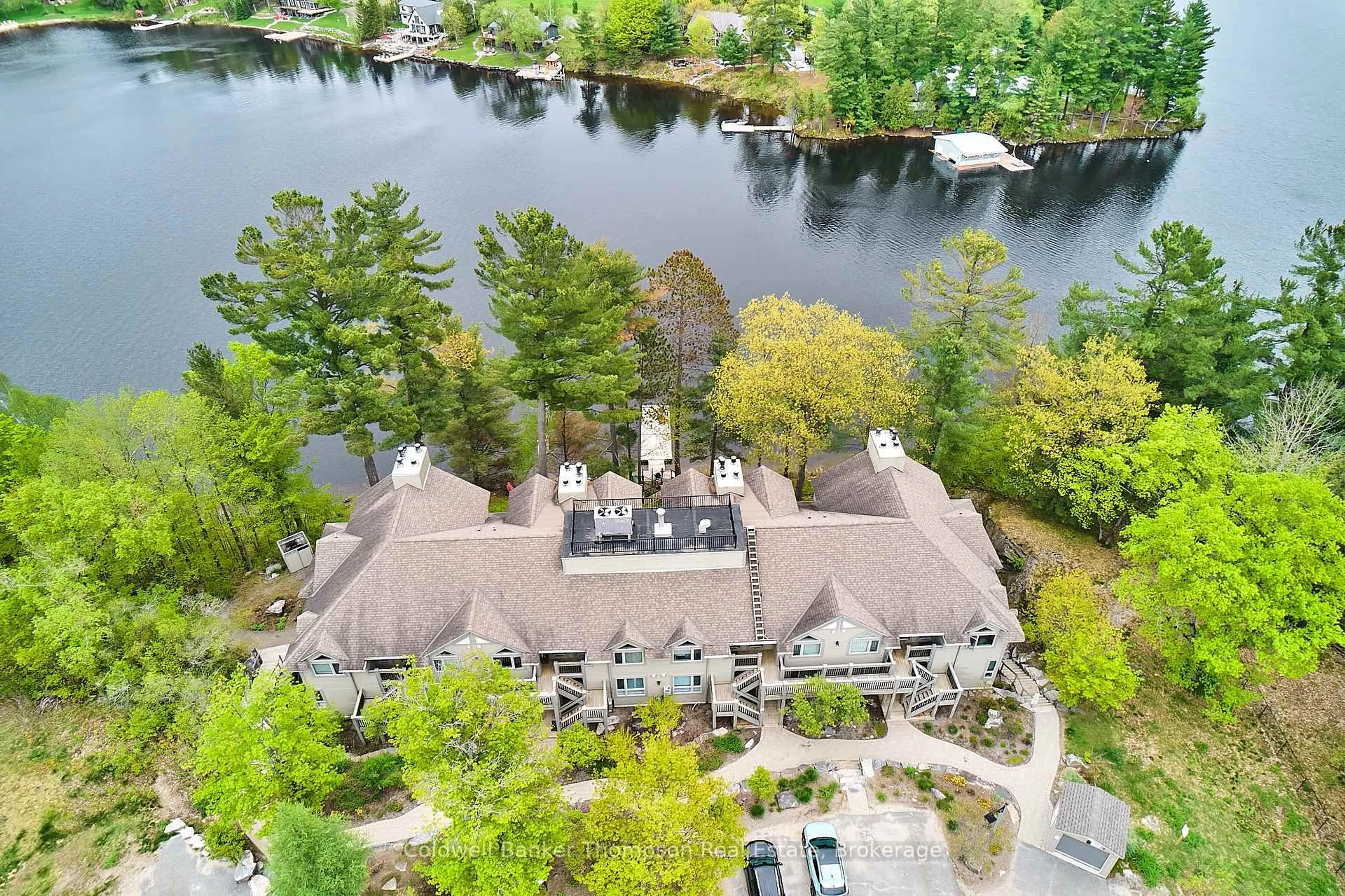 A pic from outside/outdoor area/front of a property/back of a property/a pic from drone, water/lake/river/ocean view for 5811 Grandview Signature Dr, Huntsville Ontario P1H 2N1