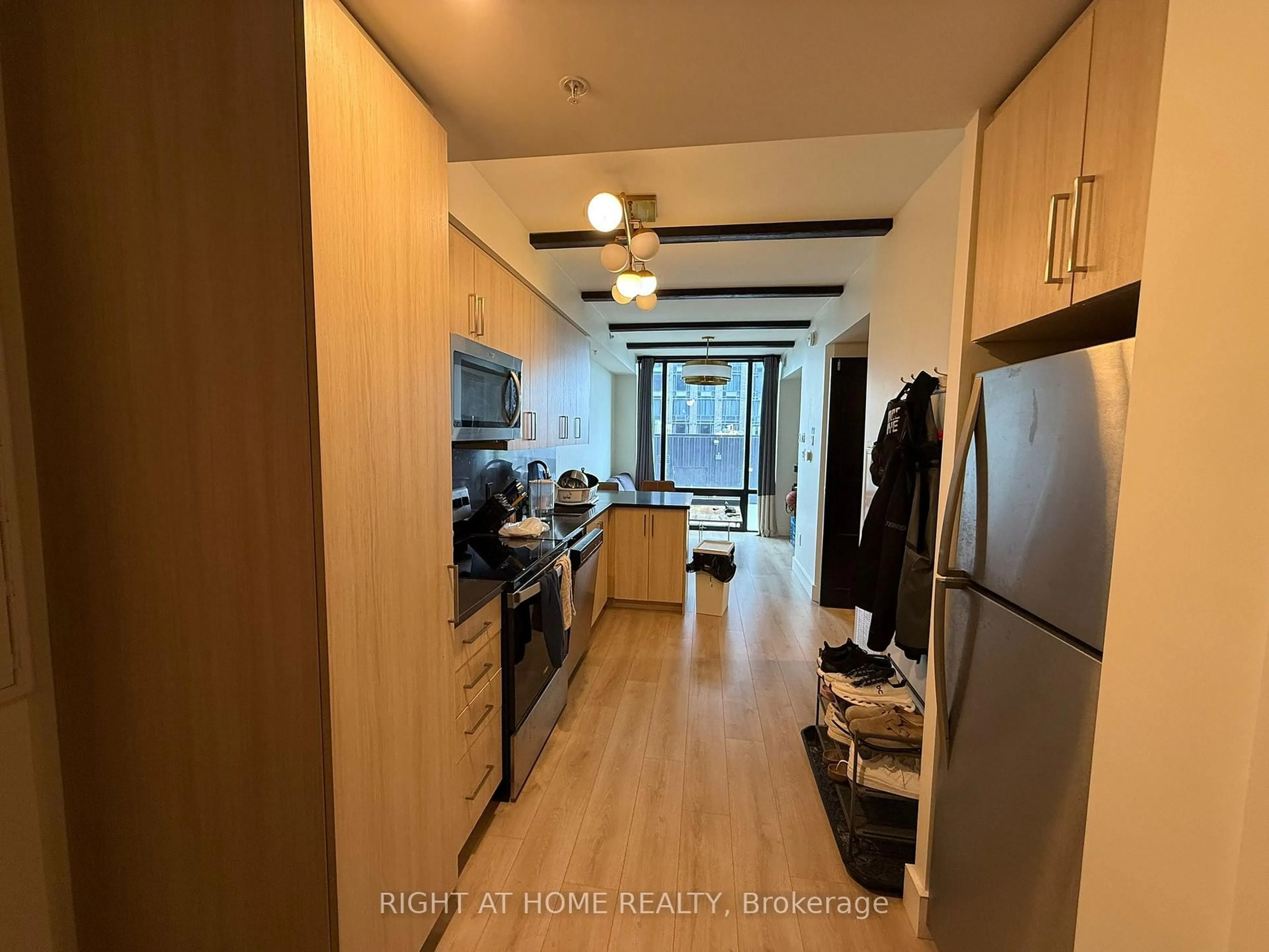 Kitchen with laundary machines, wood/laminate floor for 145 Columbia St #925, Waterloo Ontario N2L 0K7