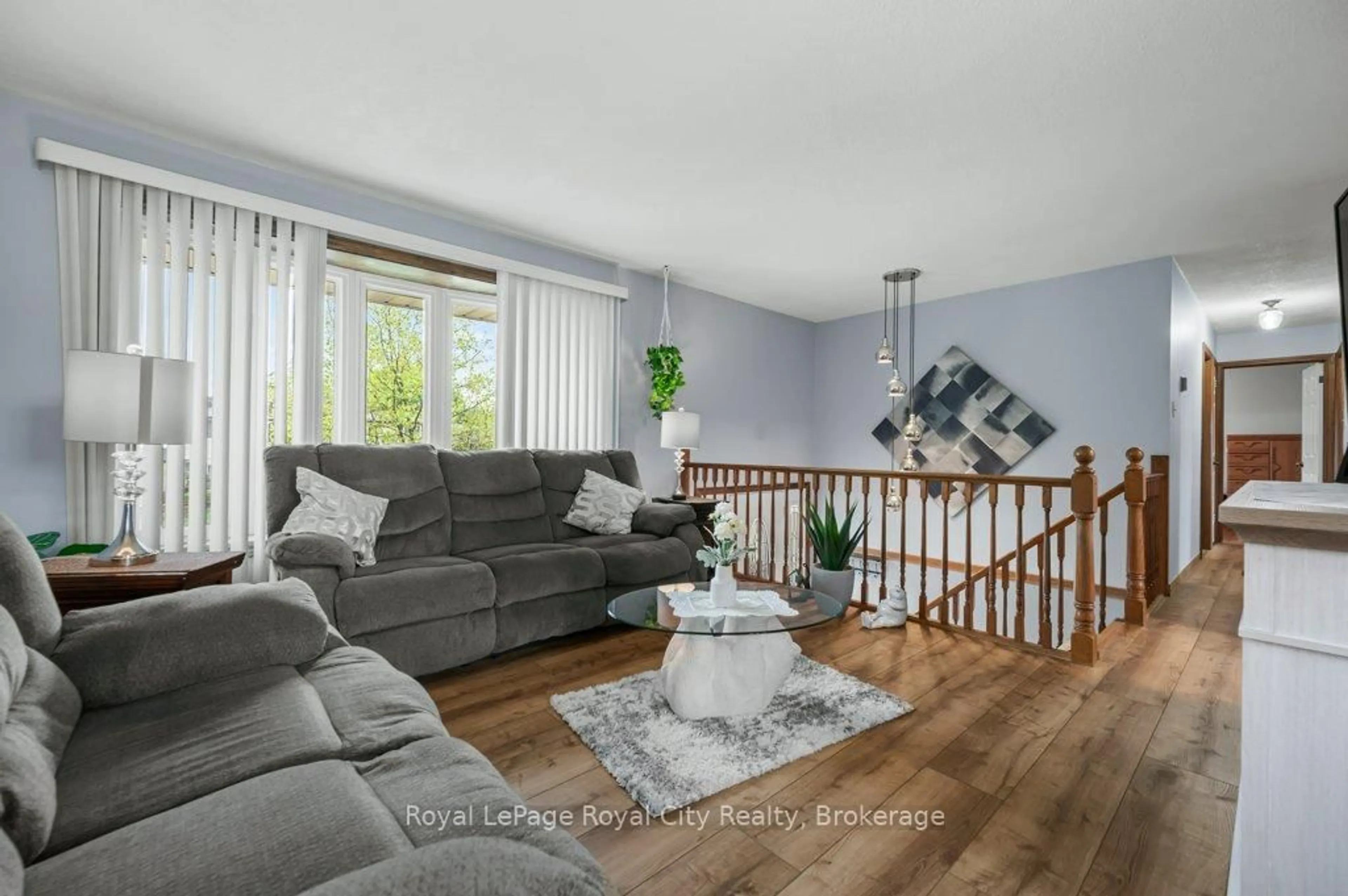 Living room with furniture, wood/laminate floor for 26 Springdale Blvd, Guelph Ontario N1H 6X5