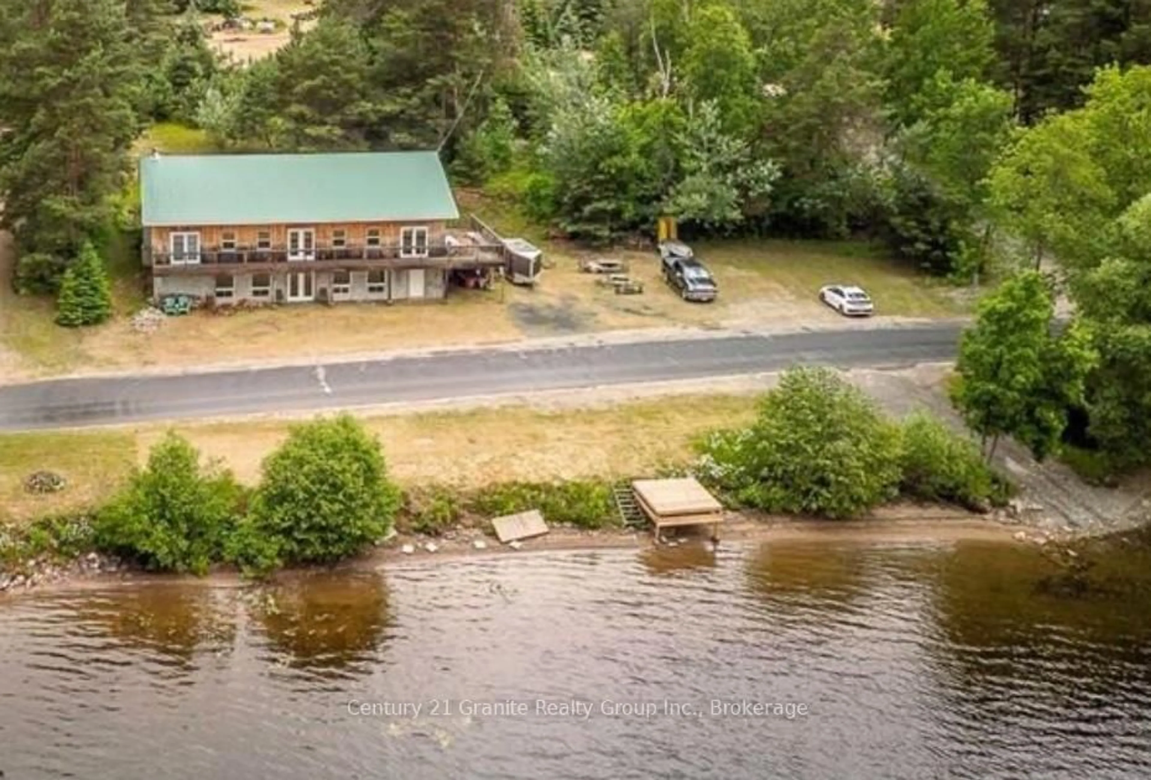 A pic from outside/outdoor area/front of a property/back of a property/a pic from drone, water/lake/river/ocean view for 1359 Green Lake Rd, Dysart et al Ontario K0M 1S0