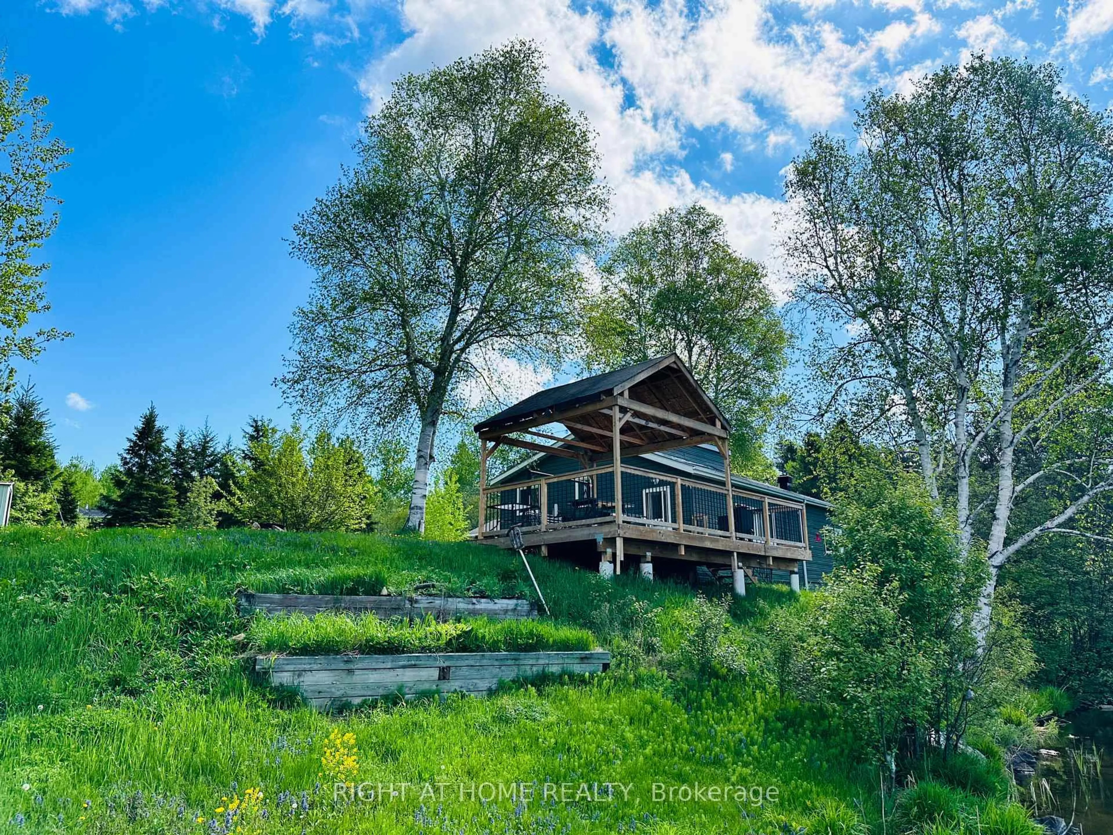 A pic from outside/outdoor area/front of a property/back of a property/a pic from drone, water/lake/river/ocean view for 33 Perrenial Lane, East Ferris Ontario P0H 1B0