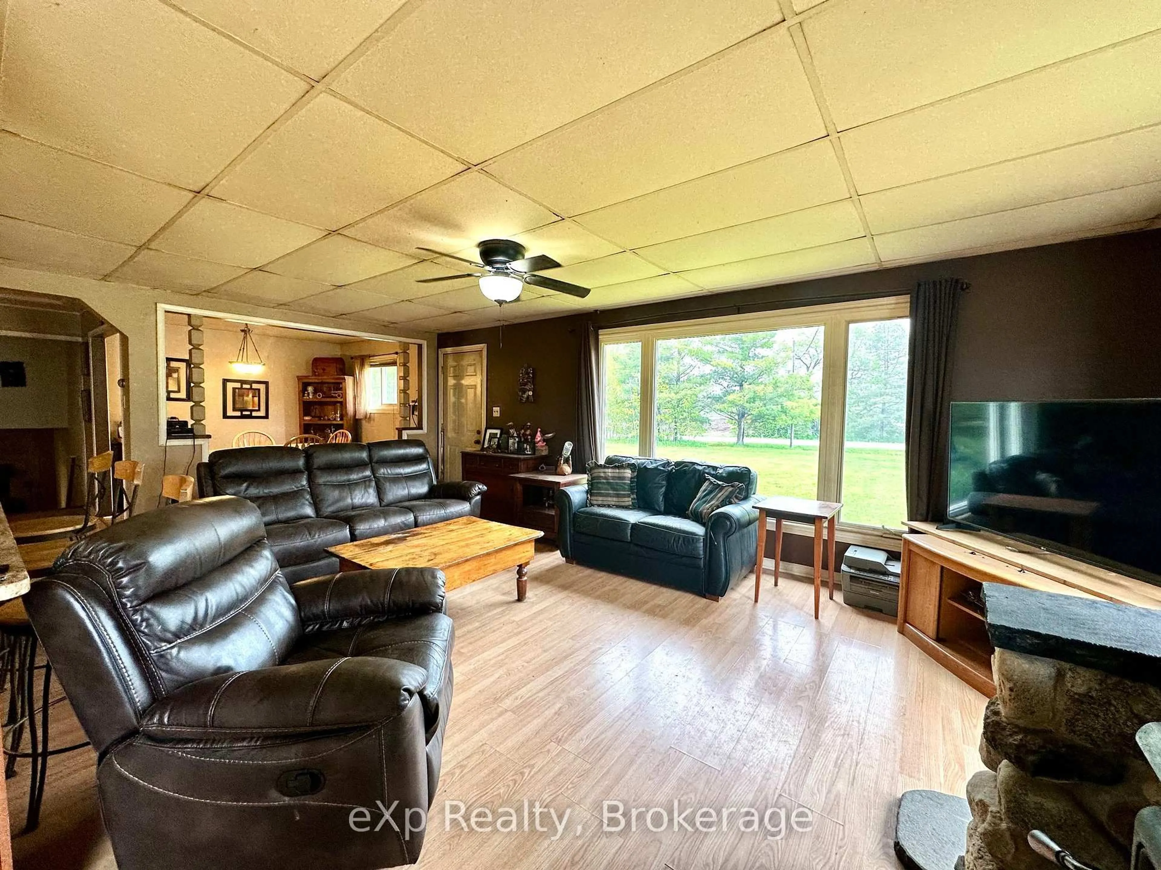 Living room with furniture, wood/laminate floor for 174364 Mulock Rd, West Grey Ontario N0G 1S0