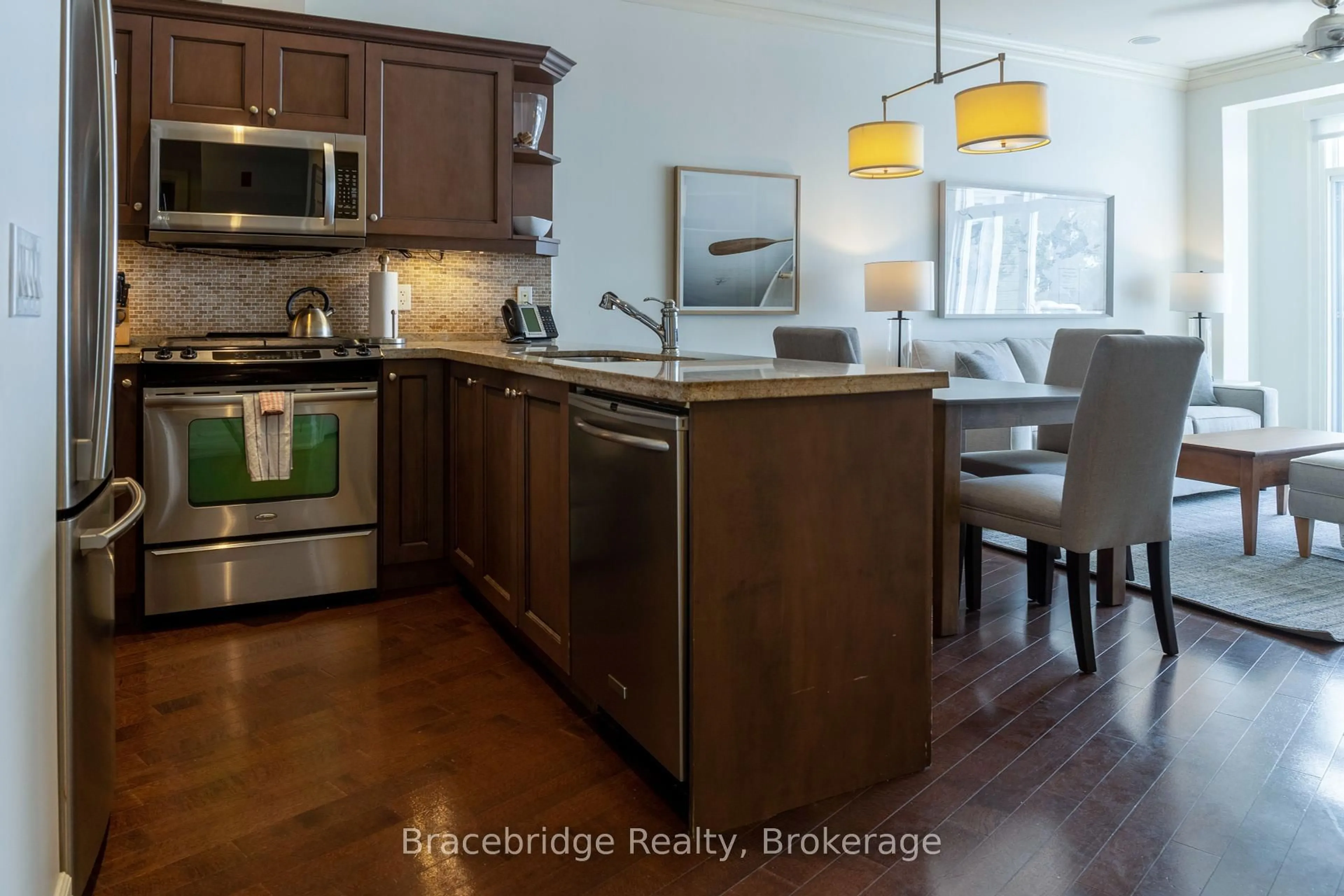 Open concept kitchen, wood/laminate floor for 1869 Muskoka 118 Rd #E206-D1, Muskoka Lakes Ontario P1L 1W8