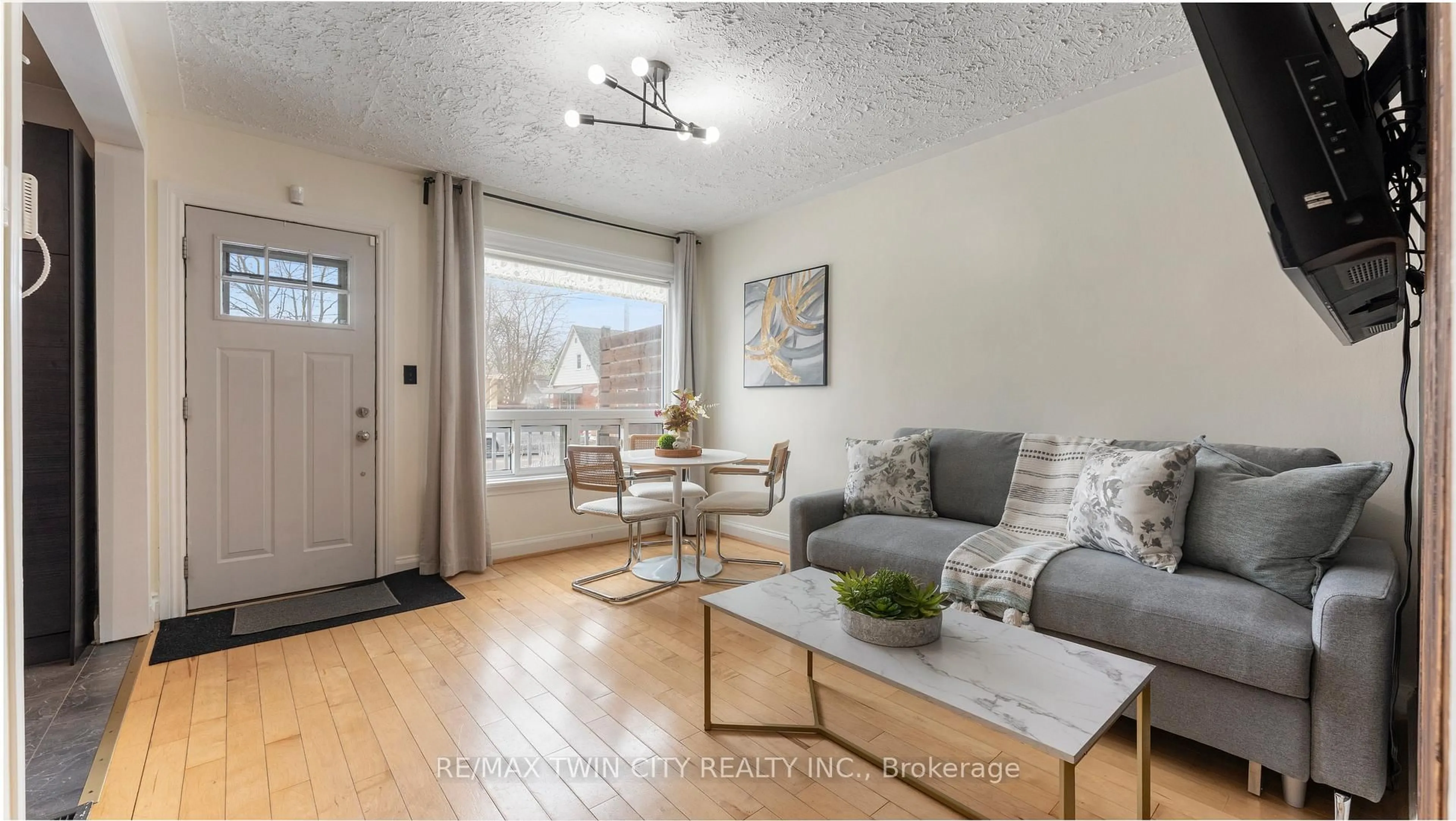 Living room with furniture, wood/laminate floor for 69 Lyons Ave, Brantford Ontario N3R 4R2