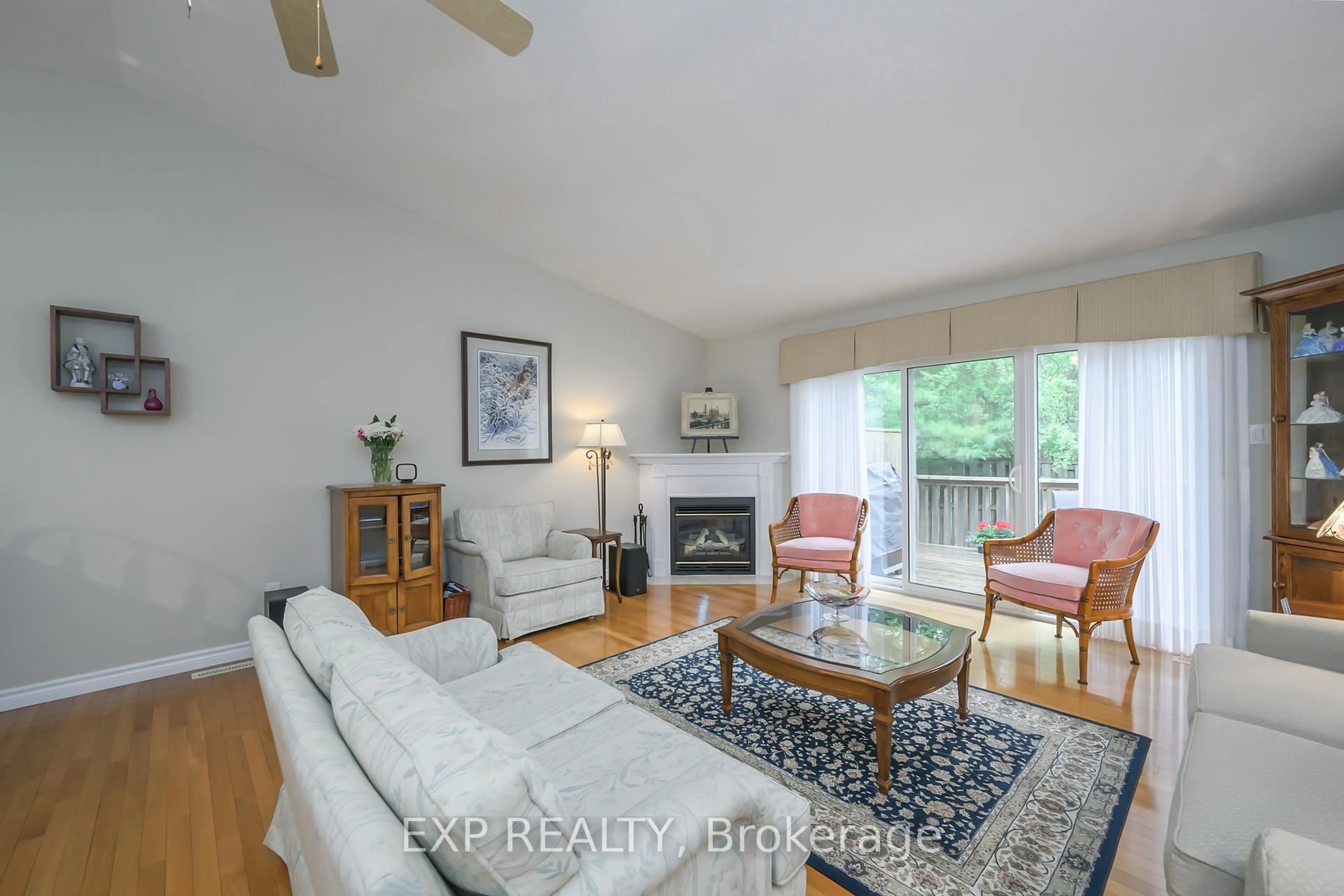Living room with furniture, wood/laminate floor for 572 Thistlewood Dr #48, London North Ontario N5X 4N7