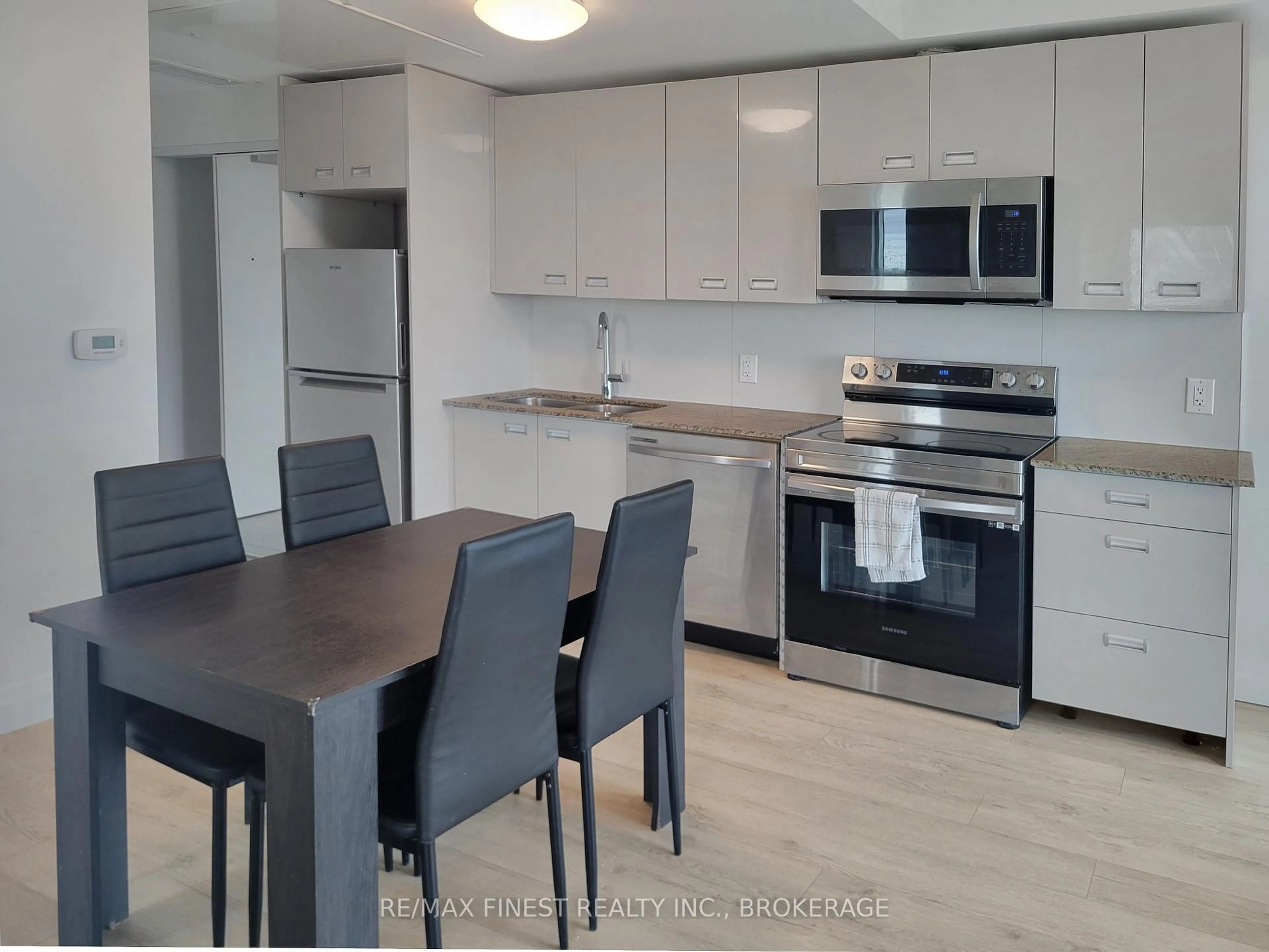 Open concept kitchen, wood/laminate floor for 652 Princess St #1031, Kingston Ontario K7L 1E5