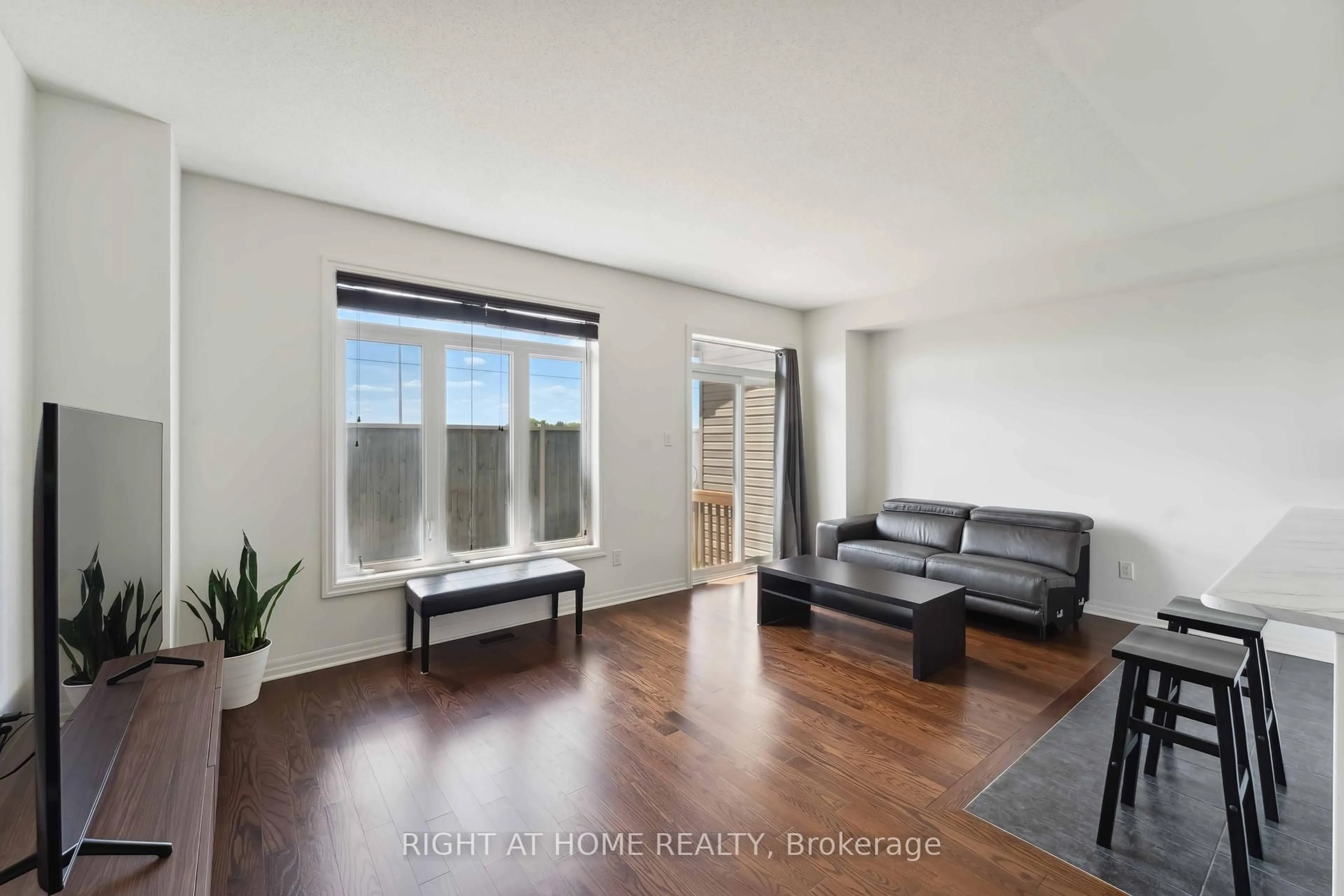 Living room with furniture, wood/laminate floor for 533 Rioja St, Ottawa Ontario K2S 0V9