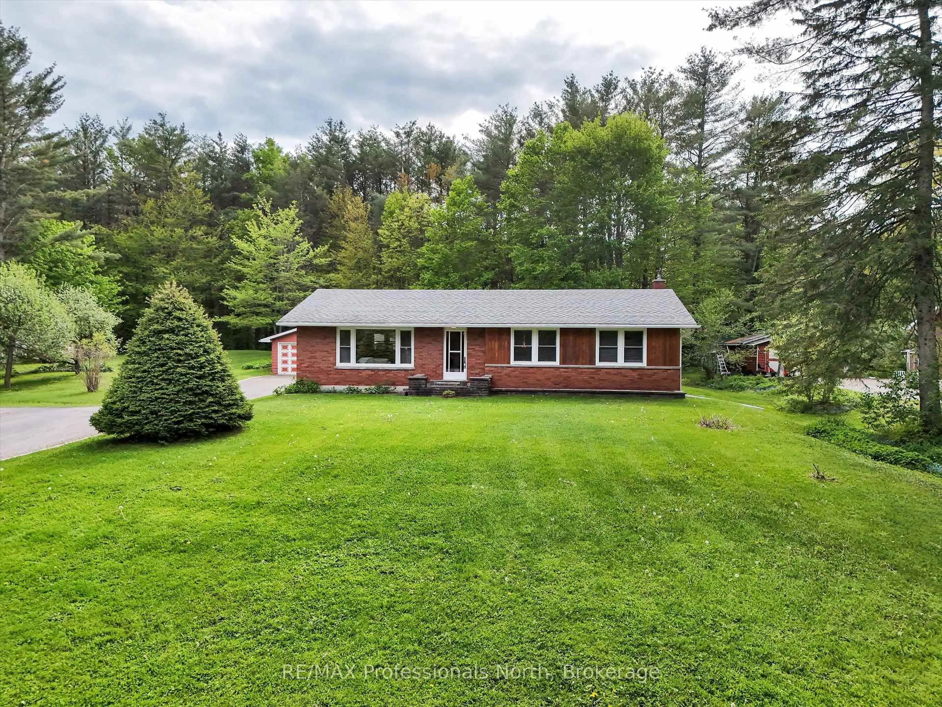 A pic from outside/outdoor area/front of a property/back of a property/a pic from drone, forest/trees view for 1166 Manitoba St, Bracebridge Ontario P1L 0K8