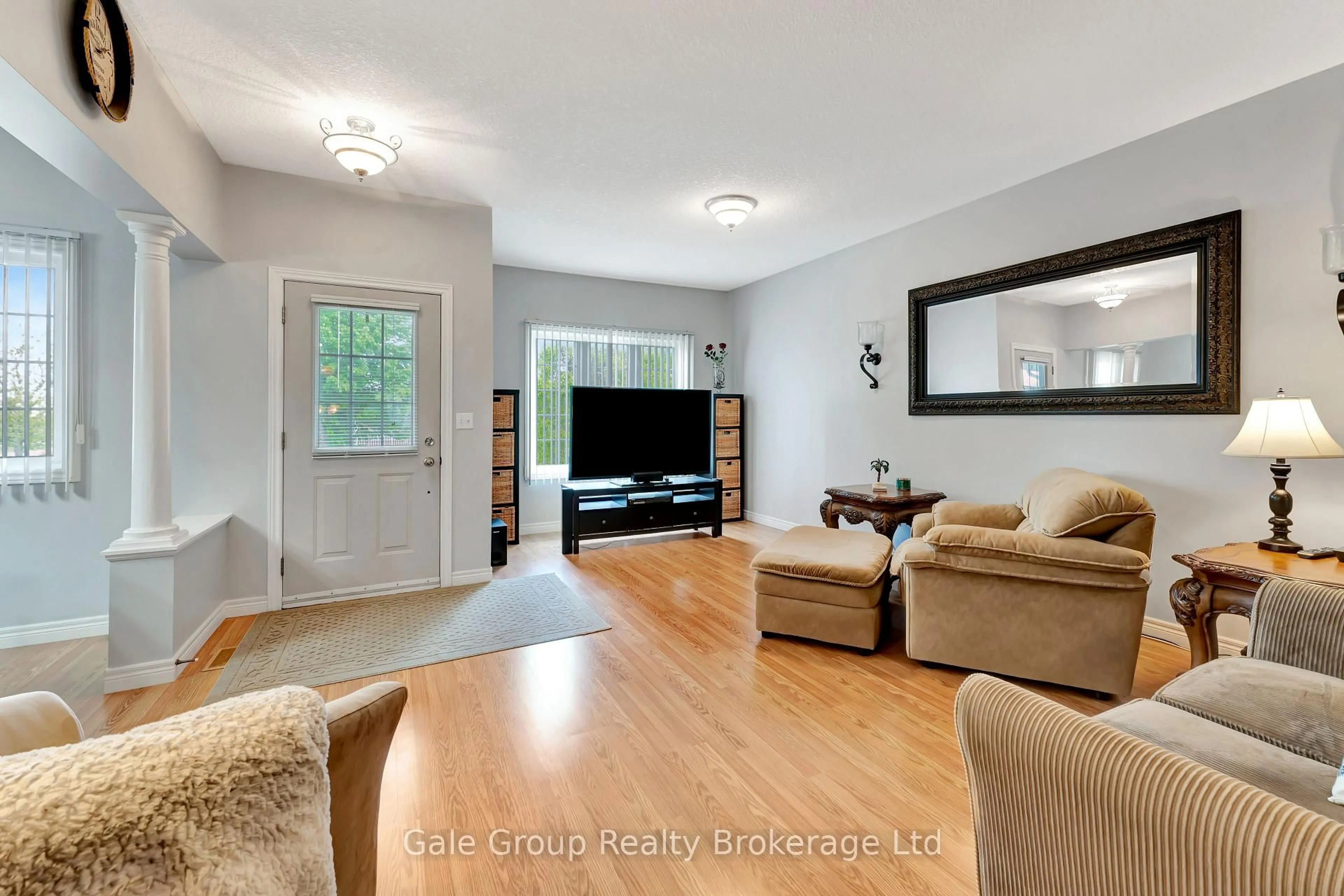 Living room with furniture, wood/laminate floor for 693 Southwood Way, Woodstock Ontario N4V 1H5