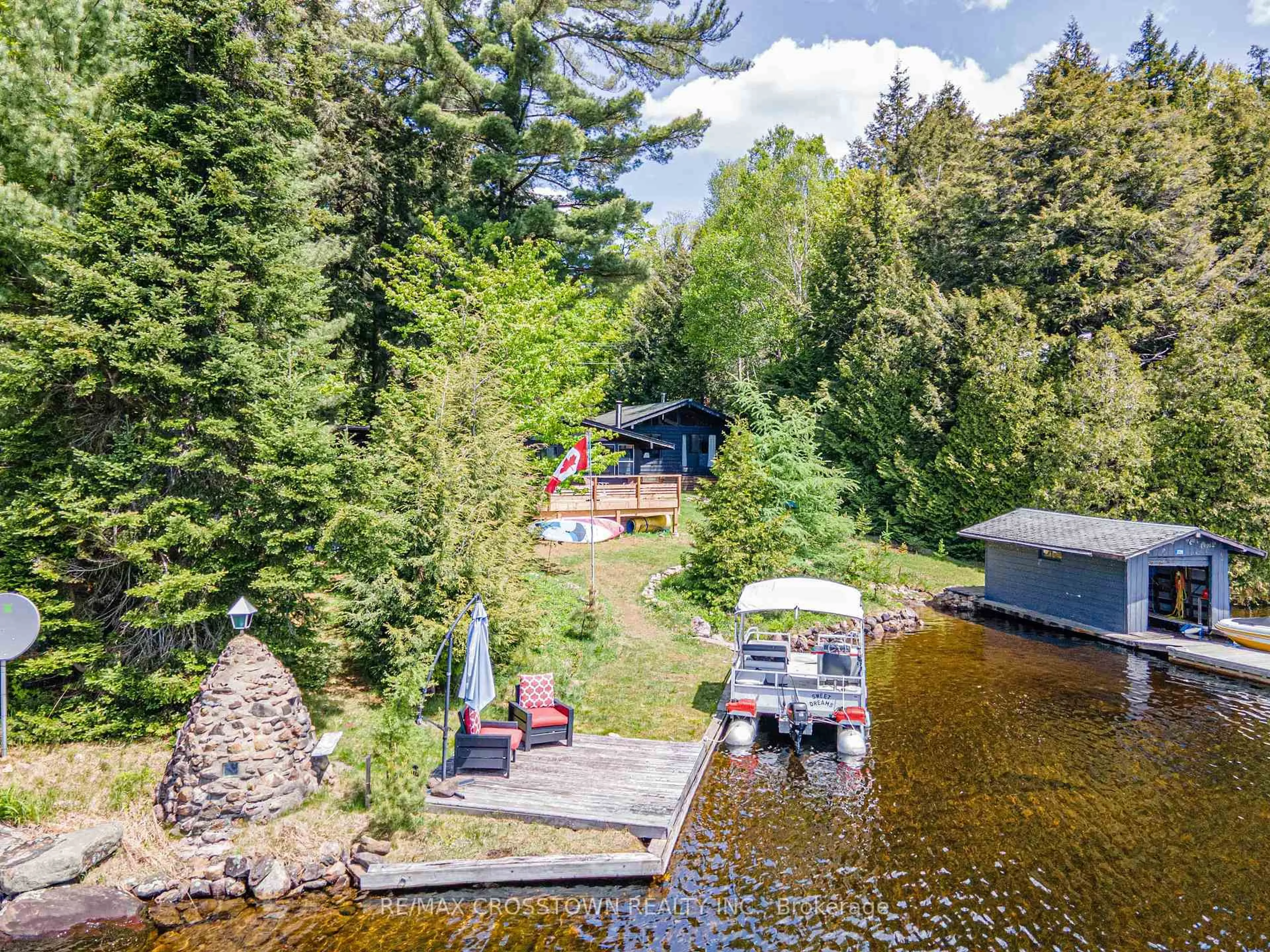 A pic from outside/outdoor area/front of a property/back of a property/a pic from drone, water/lake/river/ocean view for 228 MacBeth Island, Bracebridge Ontario P1L 1X1