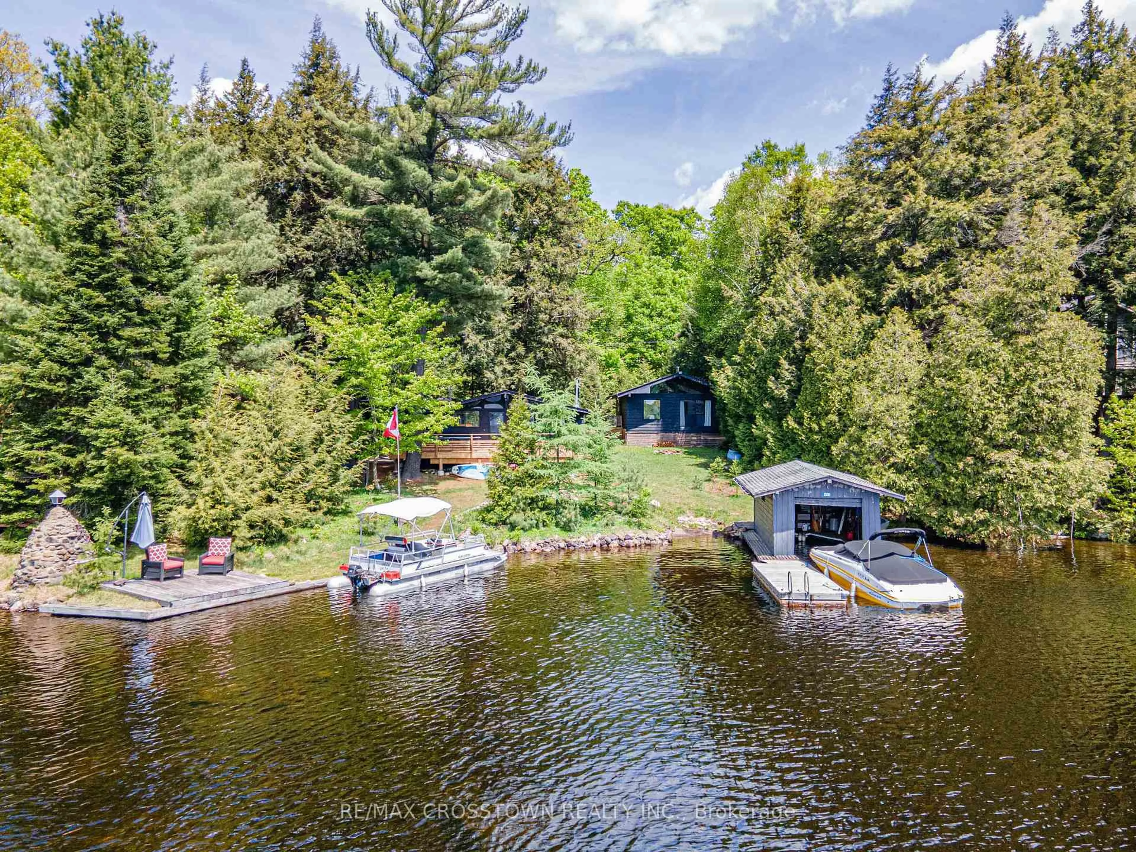 A pic from outside/outdoor area/front of a property/back of a property/a pic from drone, water/lake/river/ocean view for 228 MacBeth Island, Bracebridge Ontario P1L 1X1
