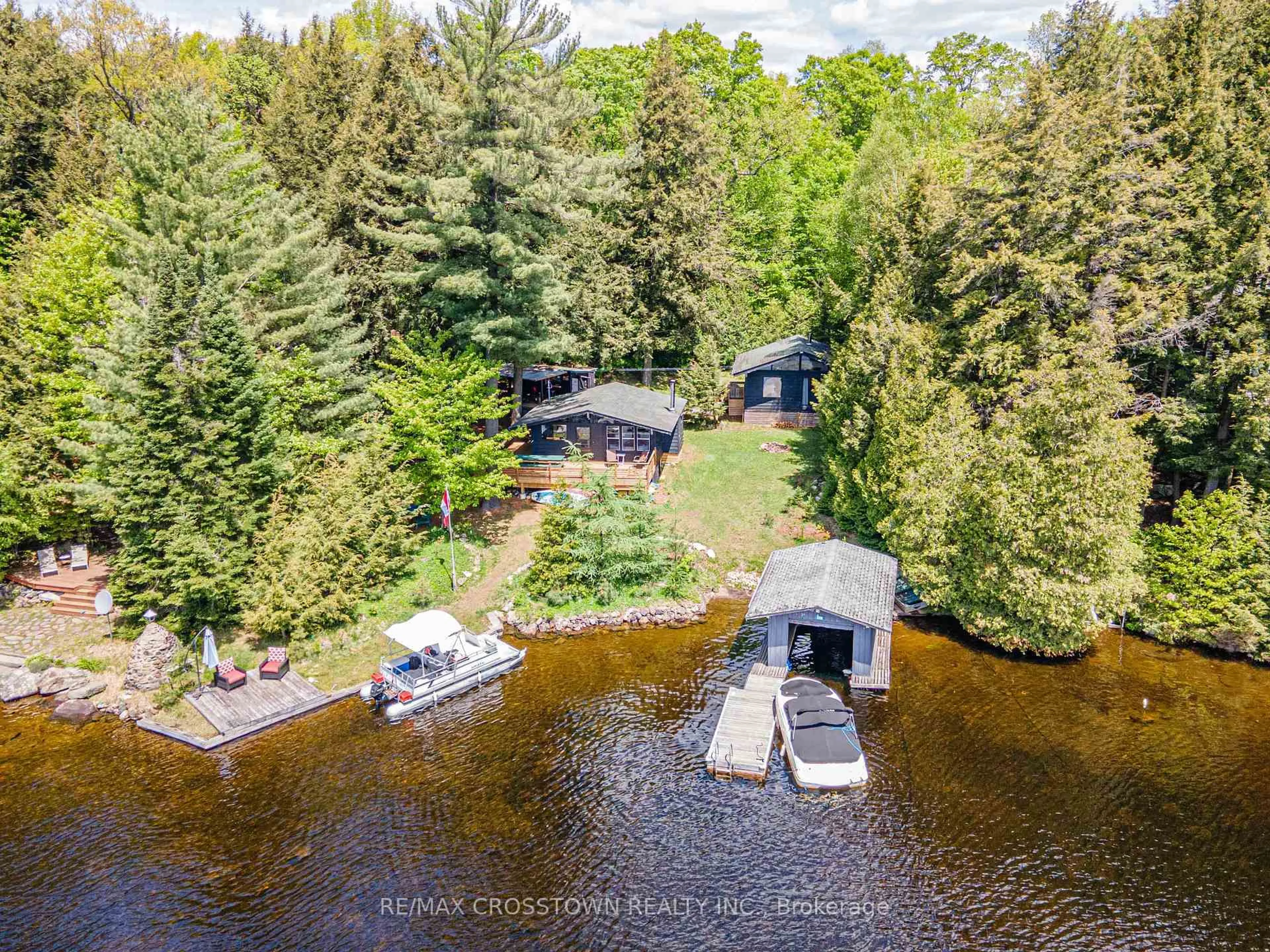 A pic from outside/outdoor area/front of a property/back of a property/a pic from drone, water/lake/river/ocean view for 228 MacBeth Island, Bracebridge Ontario P1L 1X1