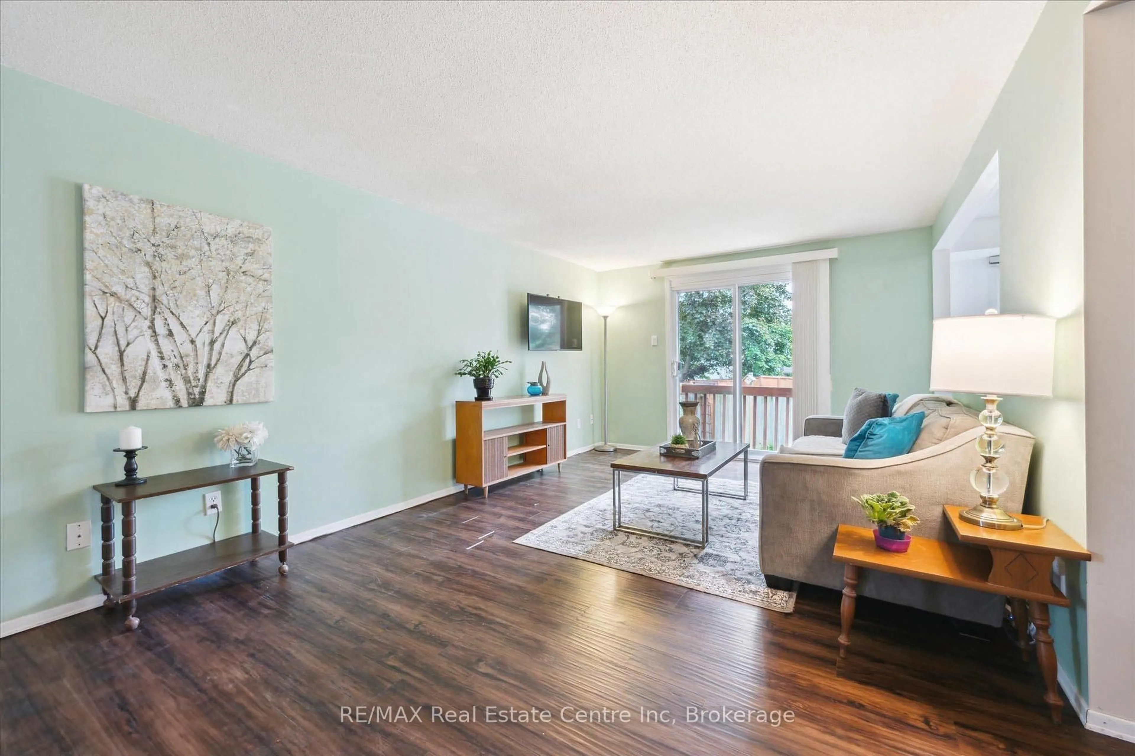 Living room with furniture, wood/laminate floor for 61 LEACOCK Ave, Guelph Ontario N1E 6P9