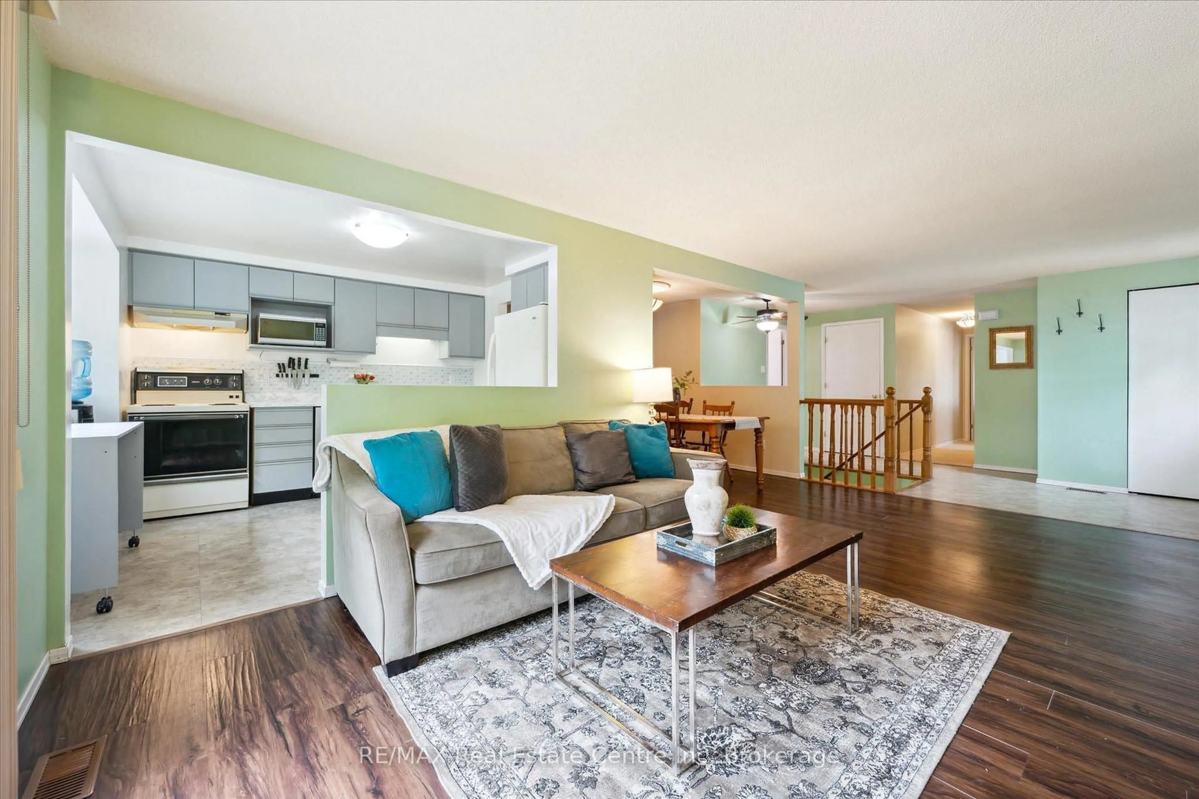 Living room with furniture, wood/laminate floor for 61 LEACOCK Ave, Guelph Ontario N1E 6P9