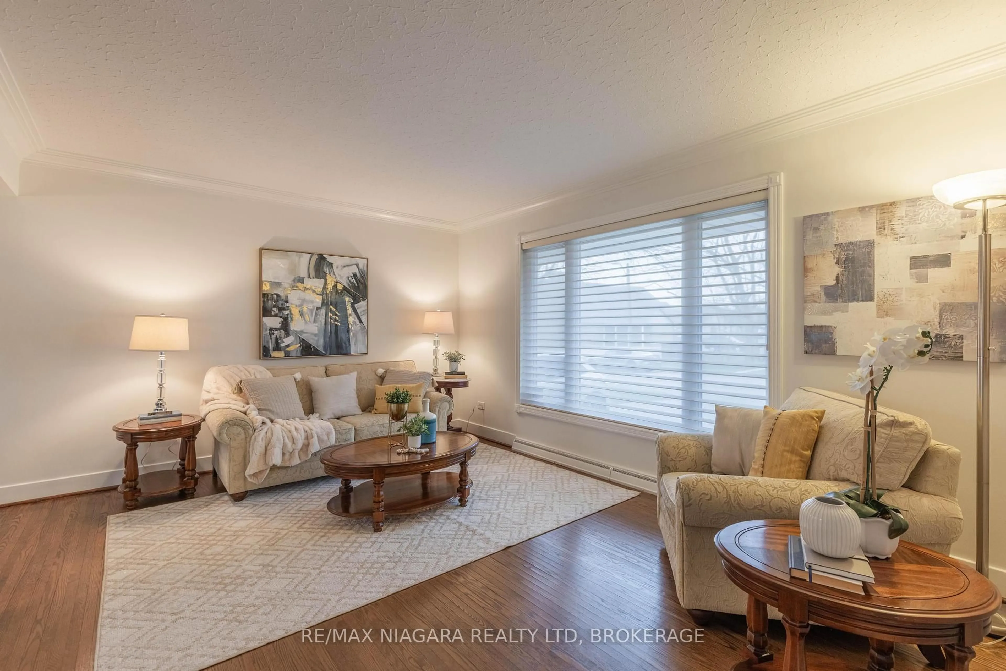 Living room with furniture, wood/laminate floor for 62 Masterson Dr, St. Catharines Ontario L2T 3P7