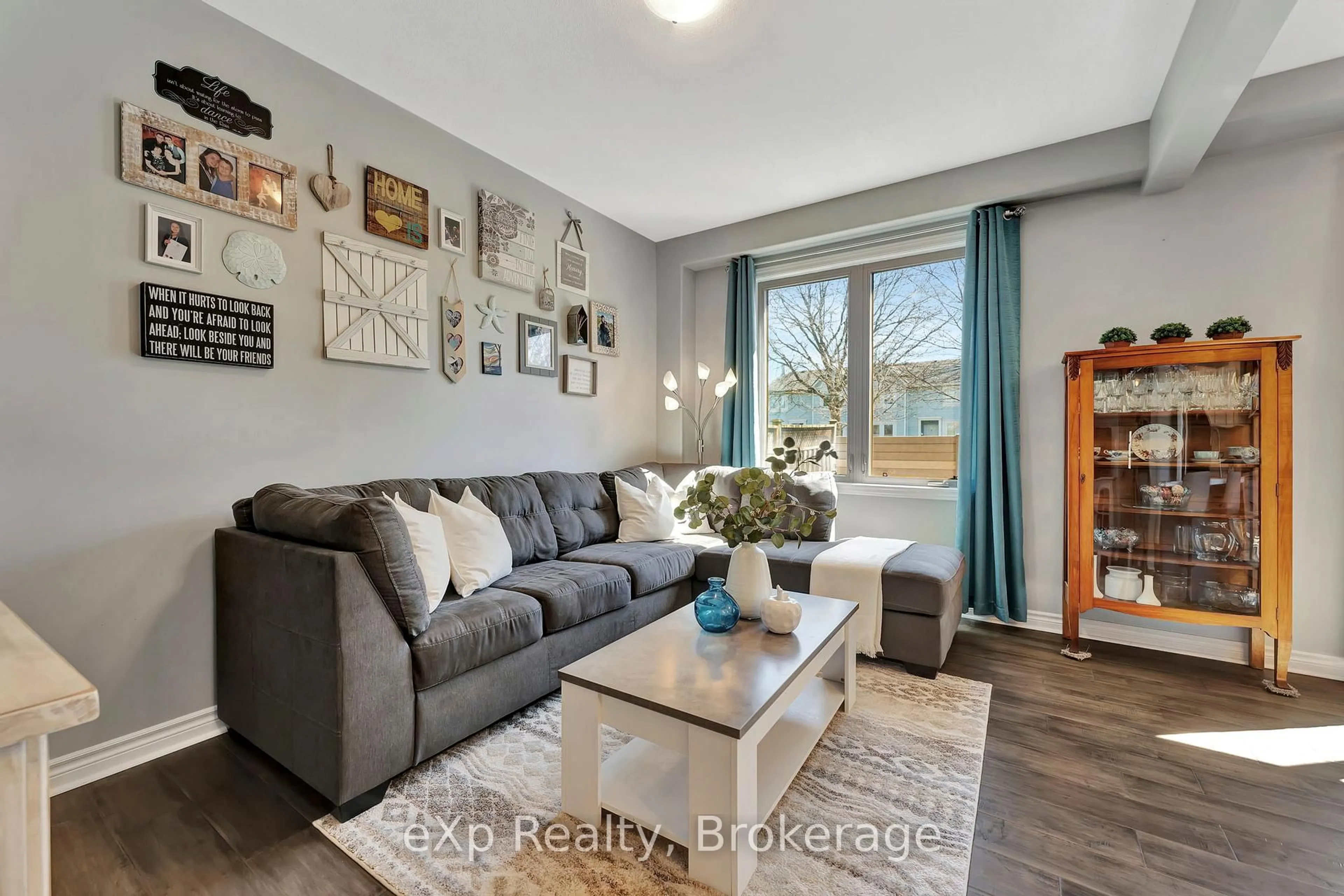 Living room with furniture, wood/laminate floor for 12 Brantwood Park Rd #D2, Brantford Ontario N3P 1G2
