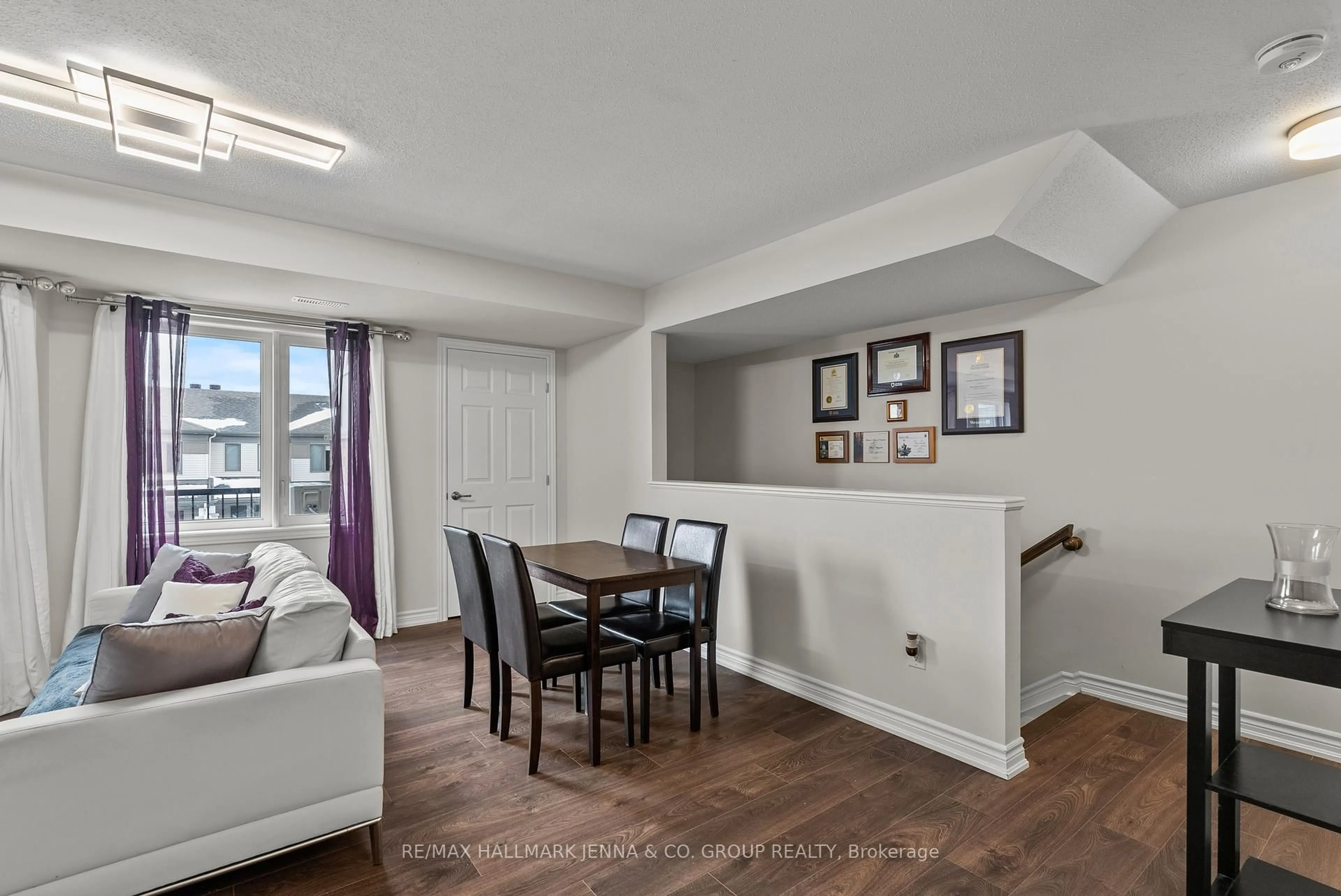 Living room with furniture, wood/laminate floor for 2302 Watercolours Way, Ottawa Ontario K2J 6N3