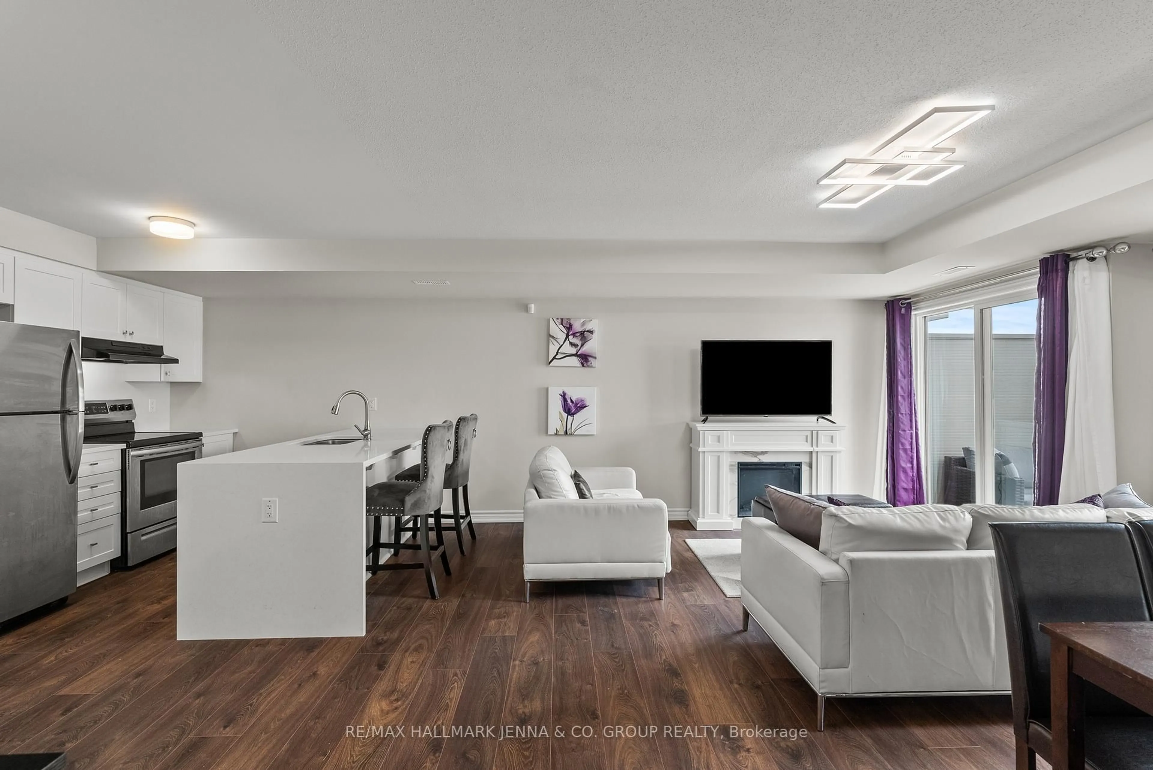 Living room with furniture, wood/laminate floor for 2302 Watercolours Way, Ottawa Ontario K2J 6N3