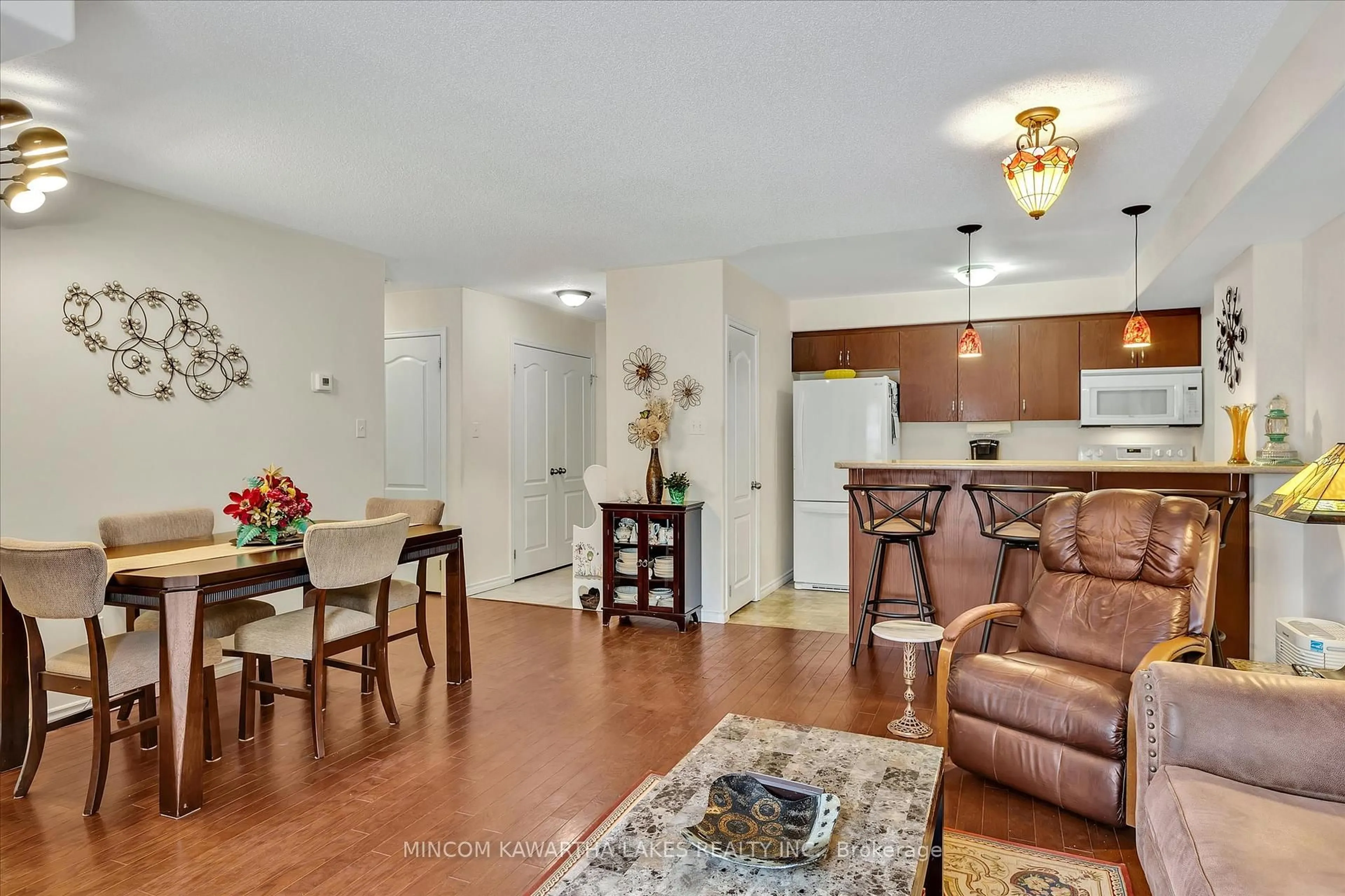 Living room with furniture, wood/laminate floor for 306 Spillsbury Dr #102, Peterborough West Ontario K9K 0B5