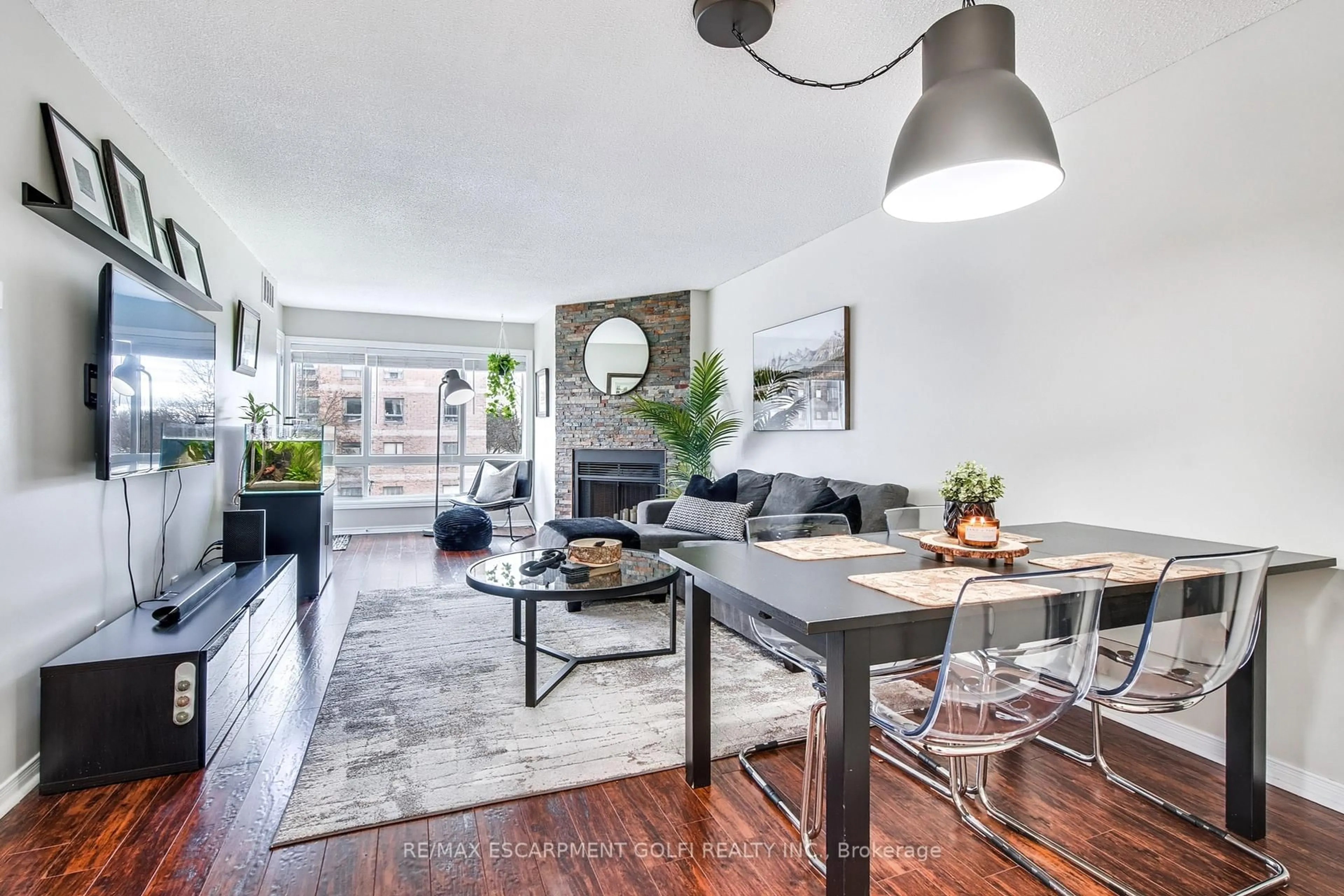 Living room with furniture, wood/laminate floor for 78 Roehampton Ave #317, St. Catharines Ontario L2M 7W9