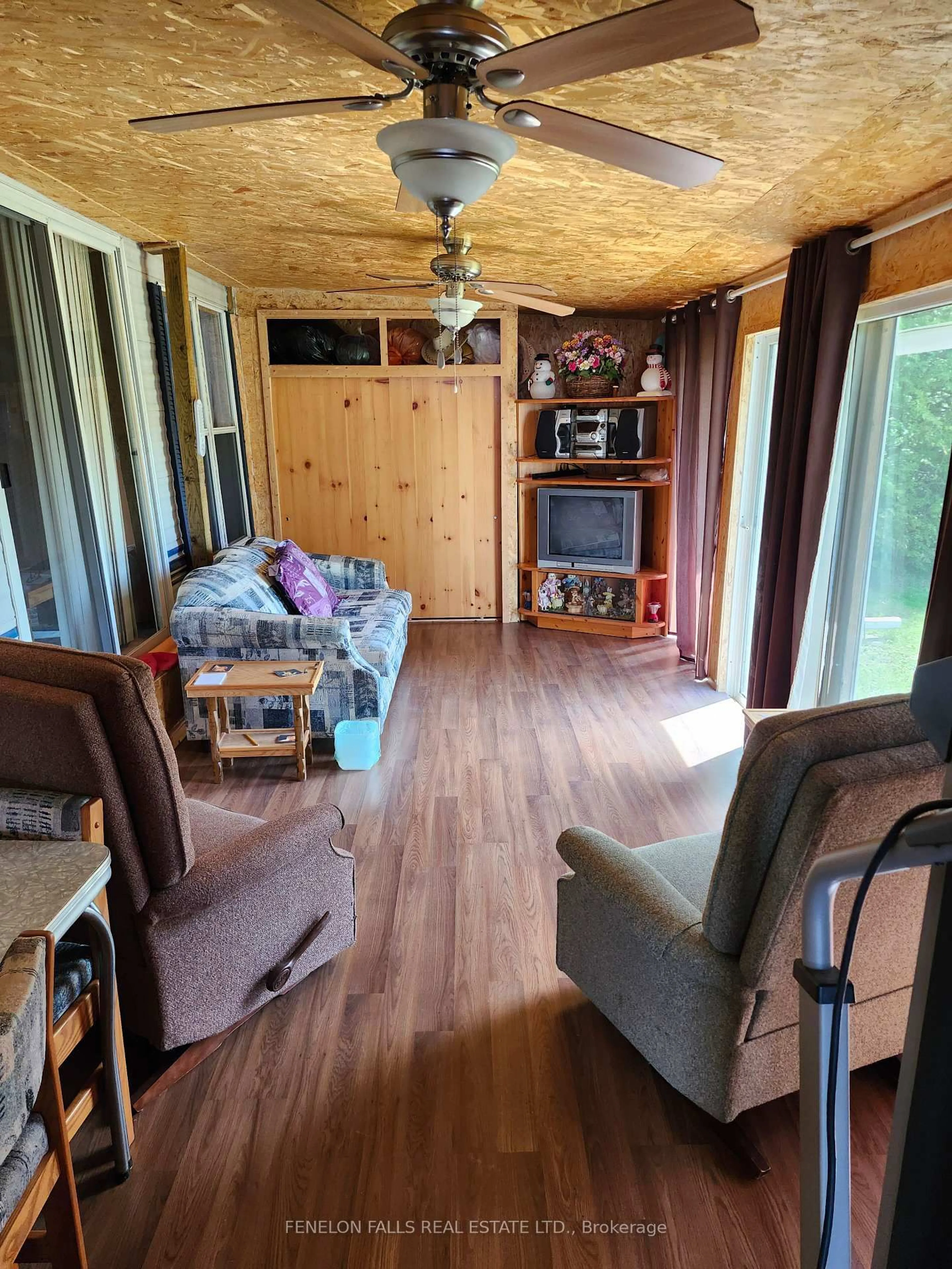 Living room with furniture, wood/laminate floor for 1802 County Road 121 Rd #133, Kawartha Lakes Ontario K0M 1N0