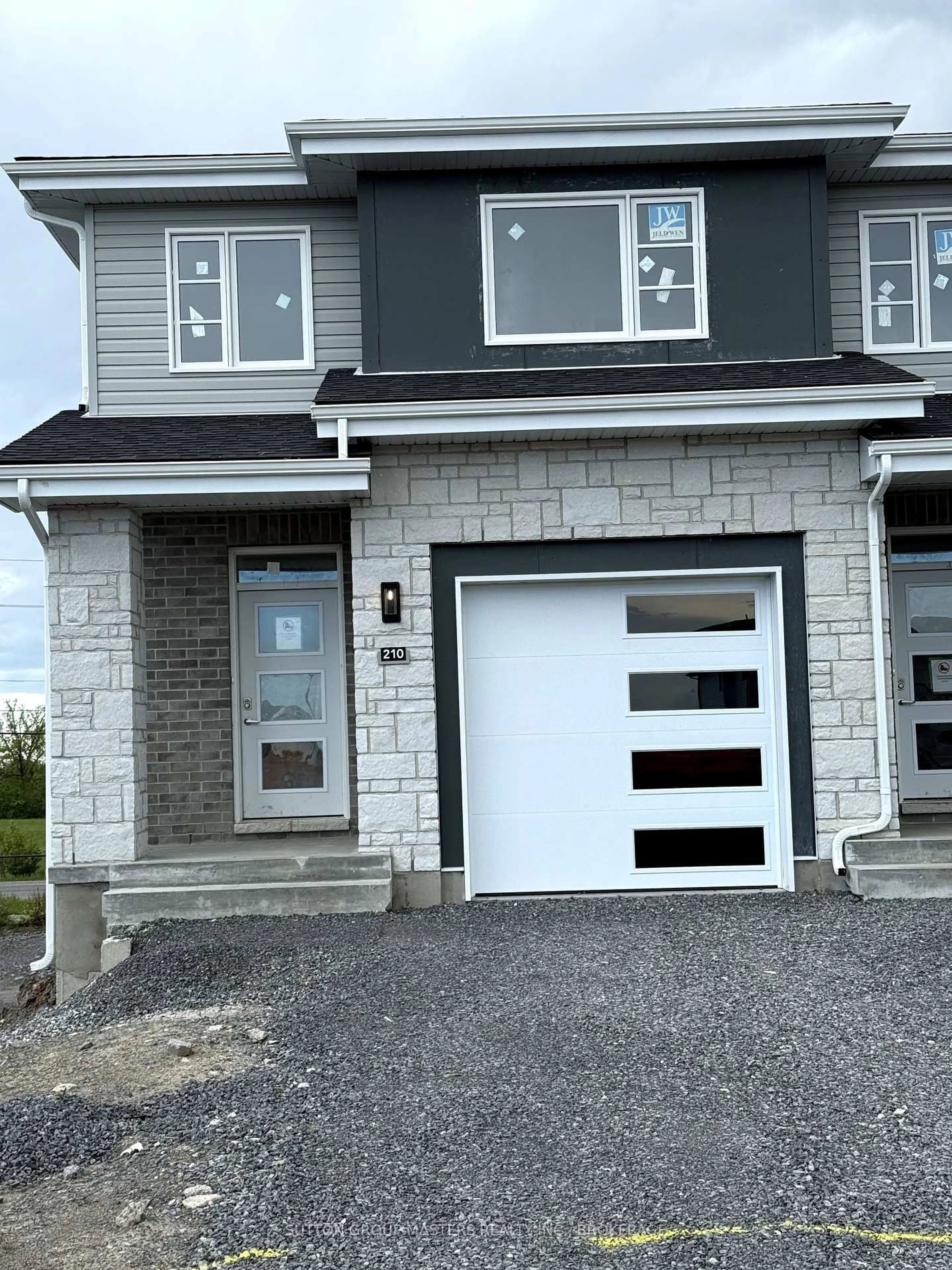 Home with vinyl exterior material, street for 210 Dr Richard James Cres, Loyalist Ontario K7N 0E9