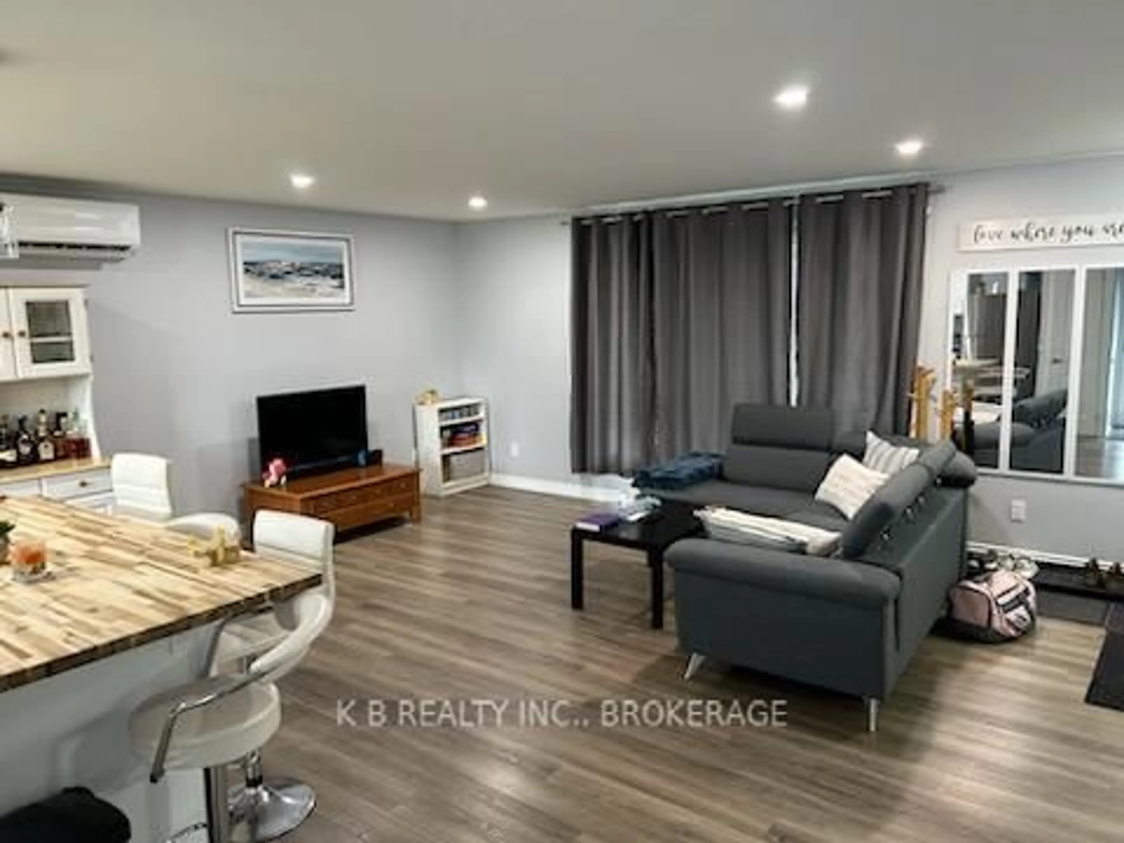 Living room with furniture, wood/laminate floor for 172 Morenz Cres, Kingston Ontario K7K 2X3