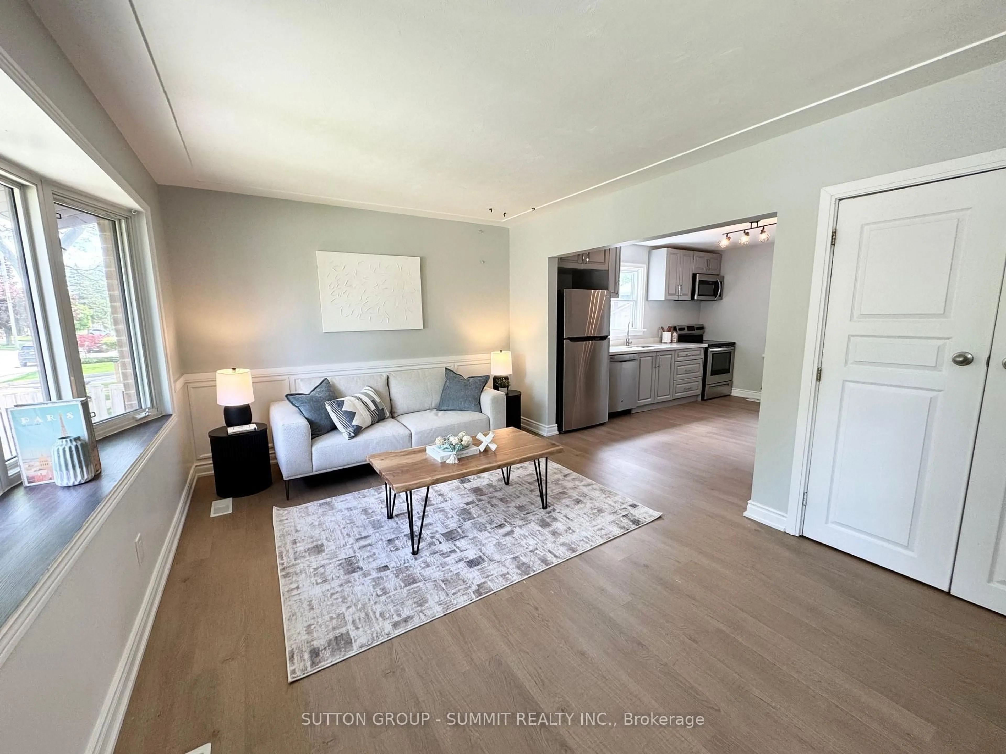 Living room with furniture, wood/laminate floor for 26 Grandfield St, Hamilton Ontario L8T 2H2