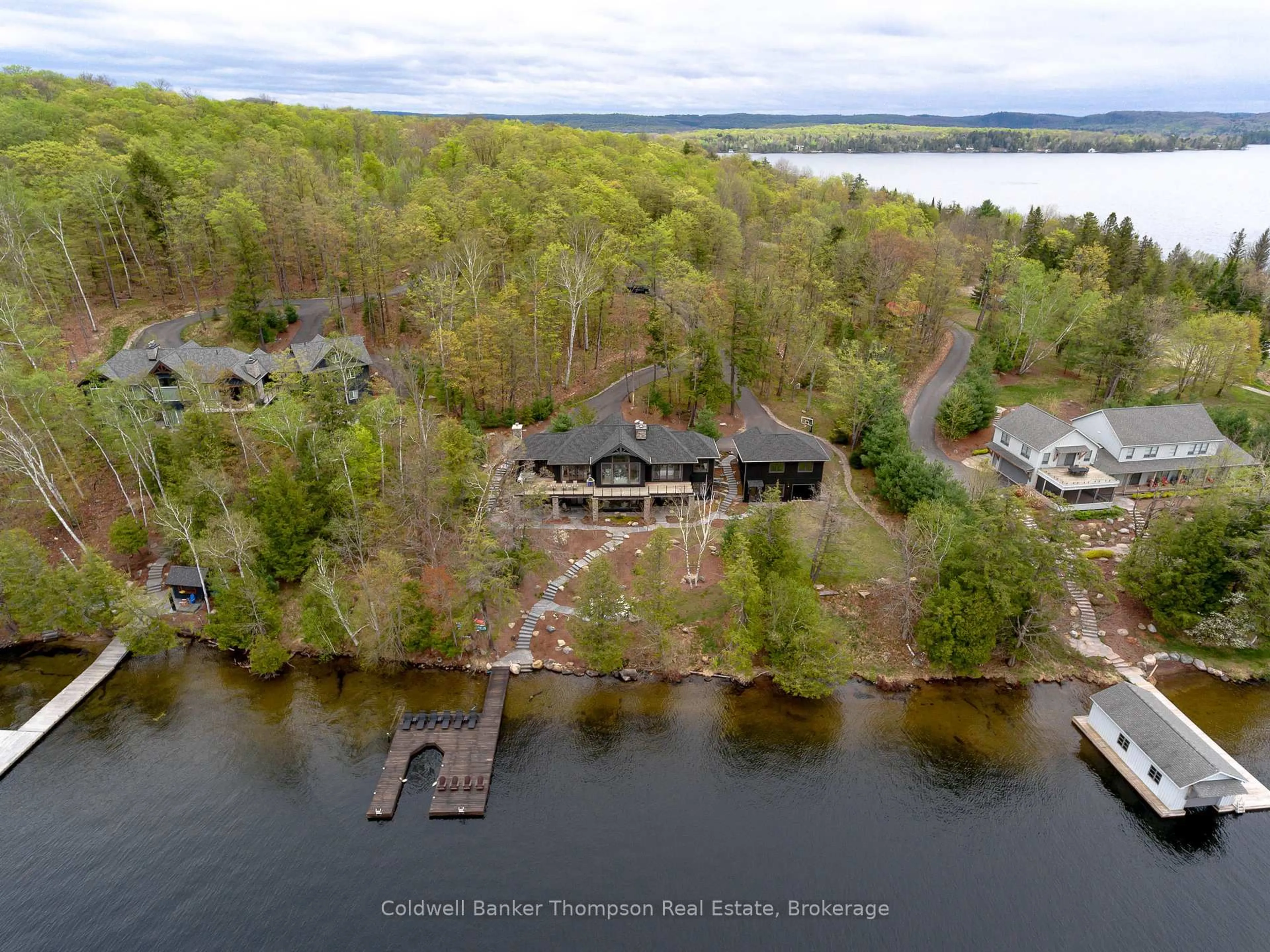 A pic from outside/outdoor area/front of a property/back of a property/a pic from drone, water/lake/river/ocean view for 414 Grassmere Resort Rd, Huntsville Ontario P1H 2J6