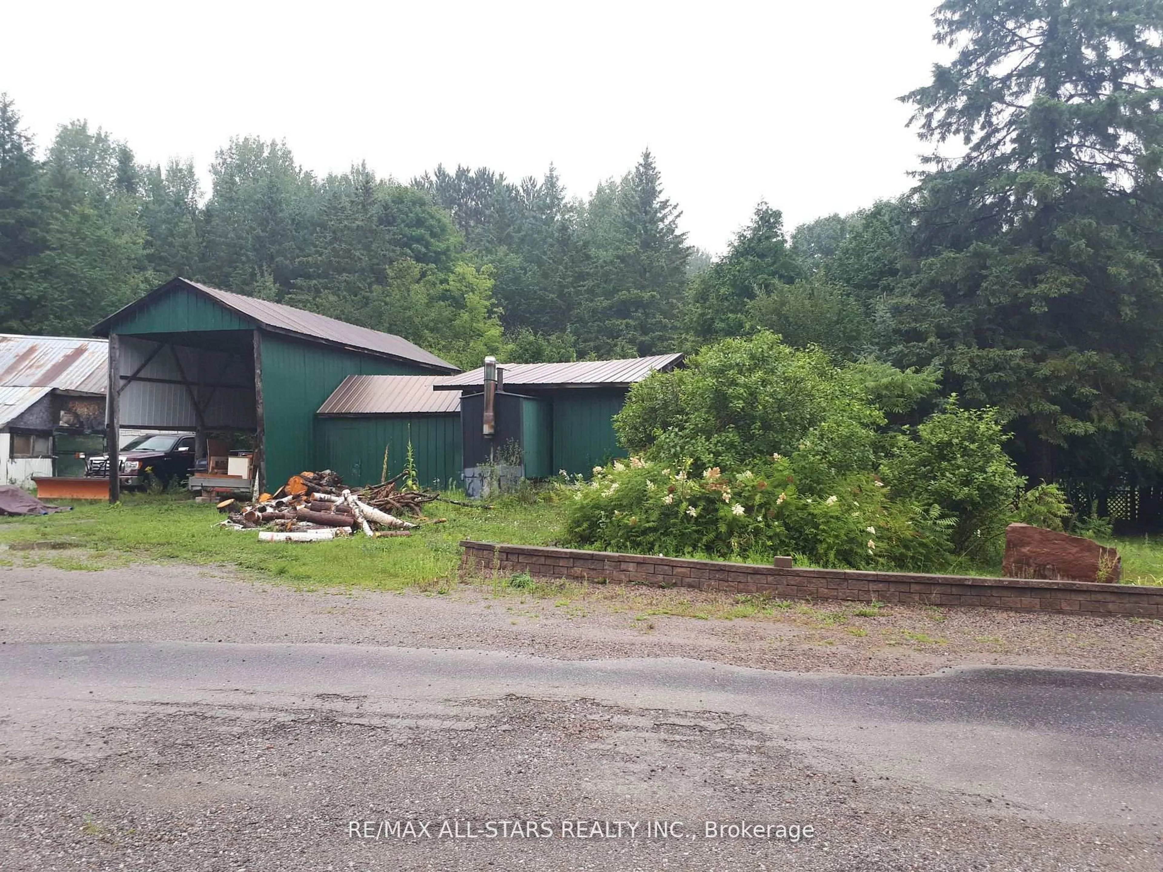 A pic from outside/outdoor area/front of a property/back of a property/a pic from drone, forest/trees view for 1007 Dewey St, Highlands East Ontario K0M 1R0
