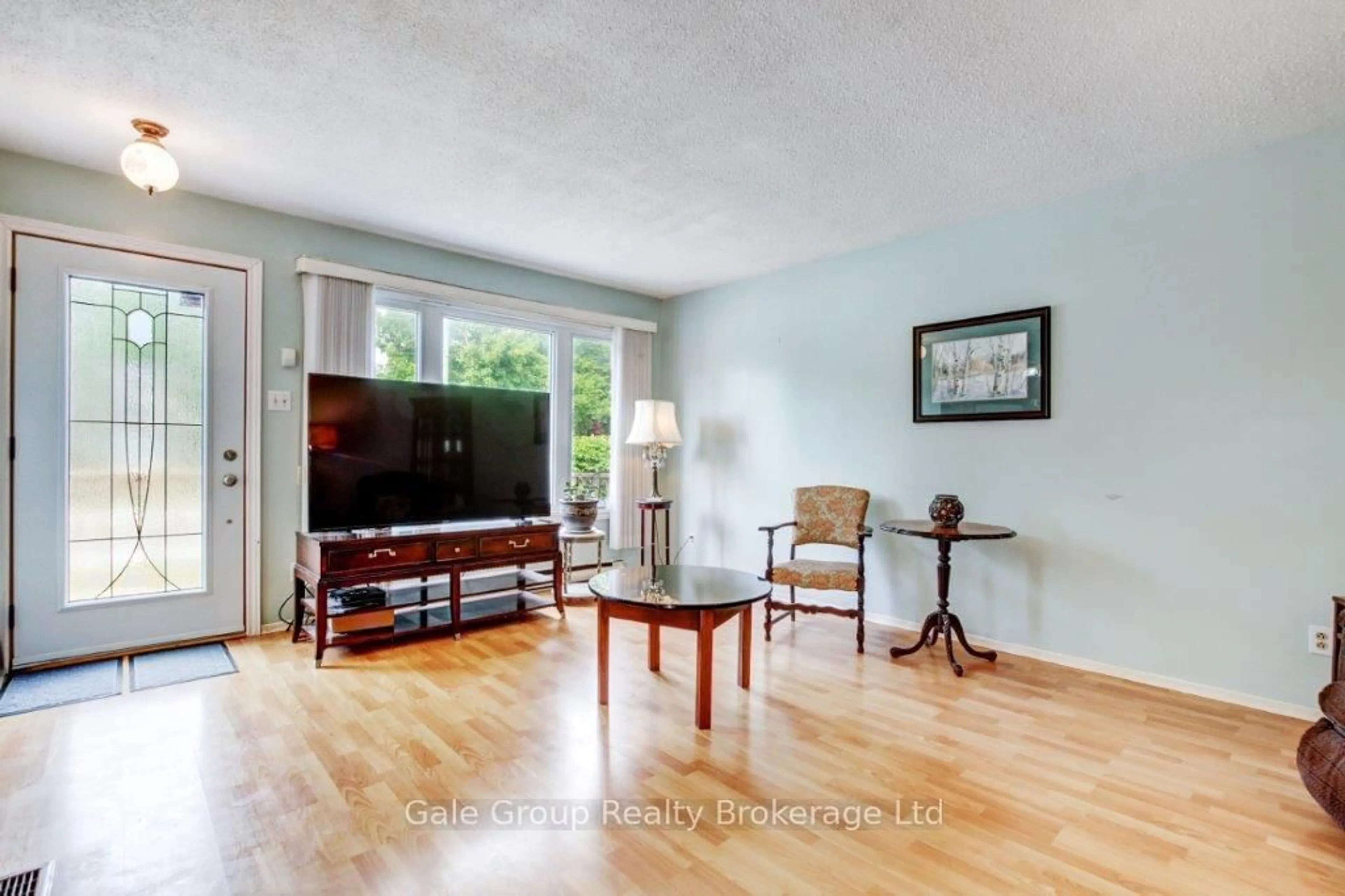 Living room with furniture, wood/laminate floor for 796 Rathbourne Ave, Woodstock Ontario N4S 4L7