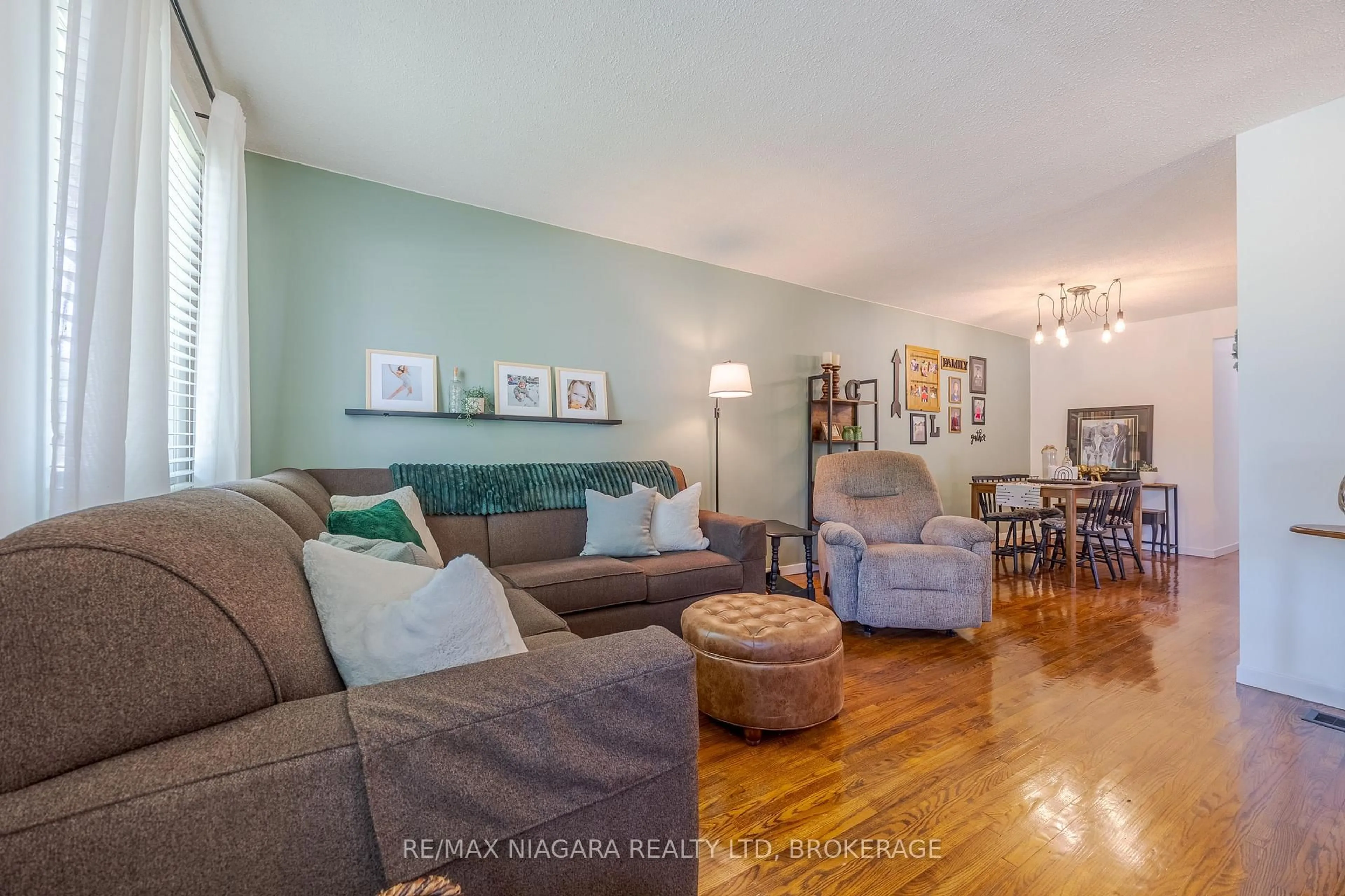 Living room with furniture, wood/laminate floor for 42 Seymour Ave, St. Catharines Ontario L2P 1A7