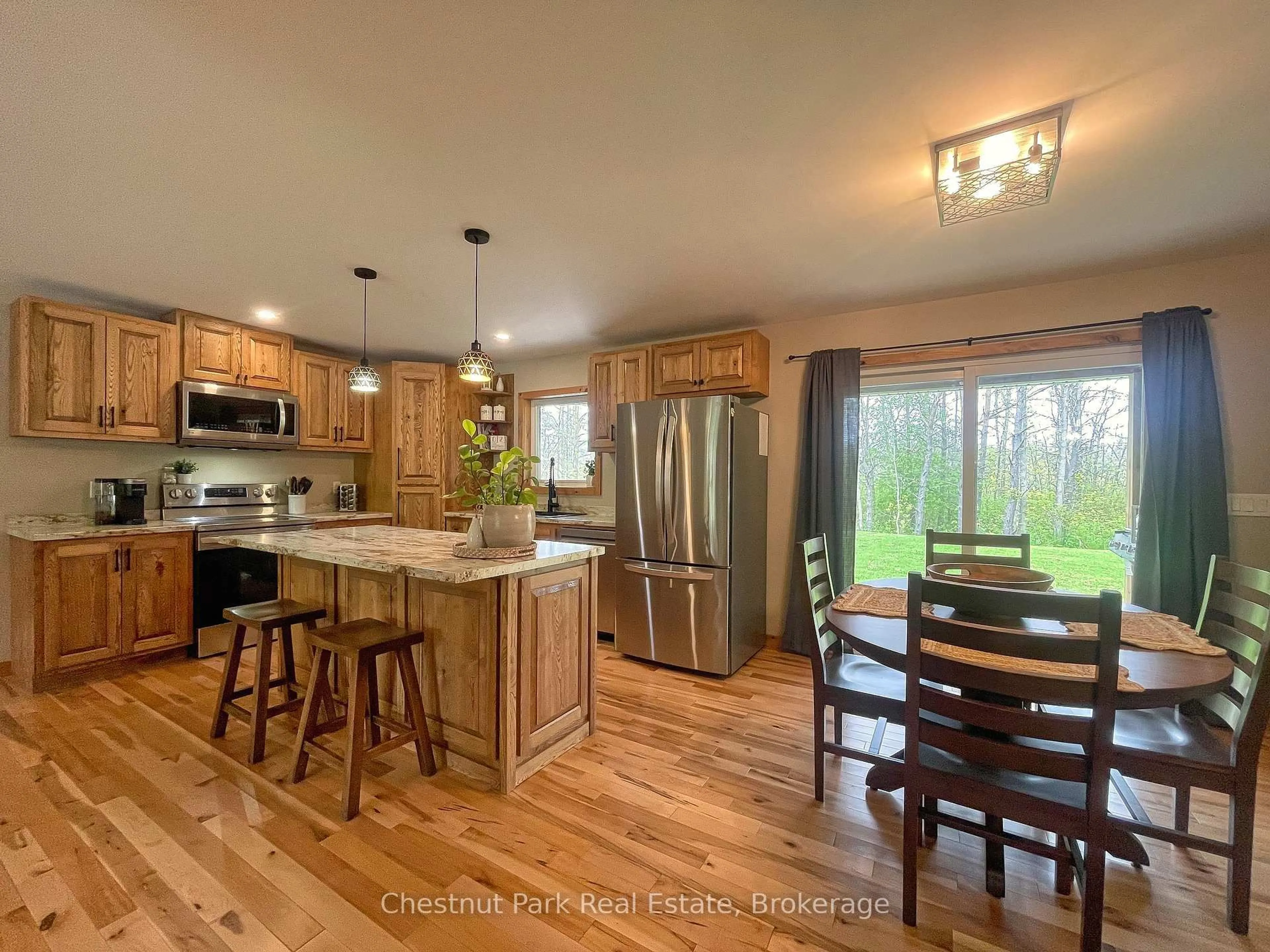 Open concept kitchen, wood/laminate floor for 23 Maple Dr, Northern Bruce Peninsula Ontario N0H 1Z0