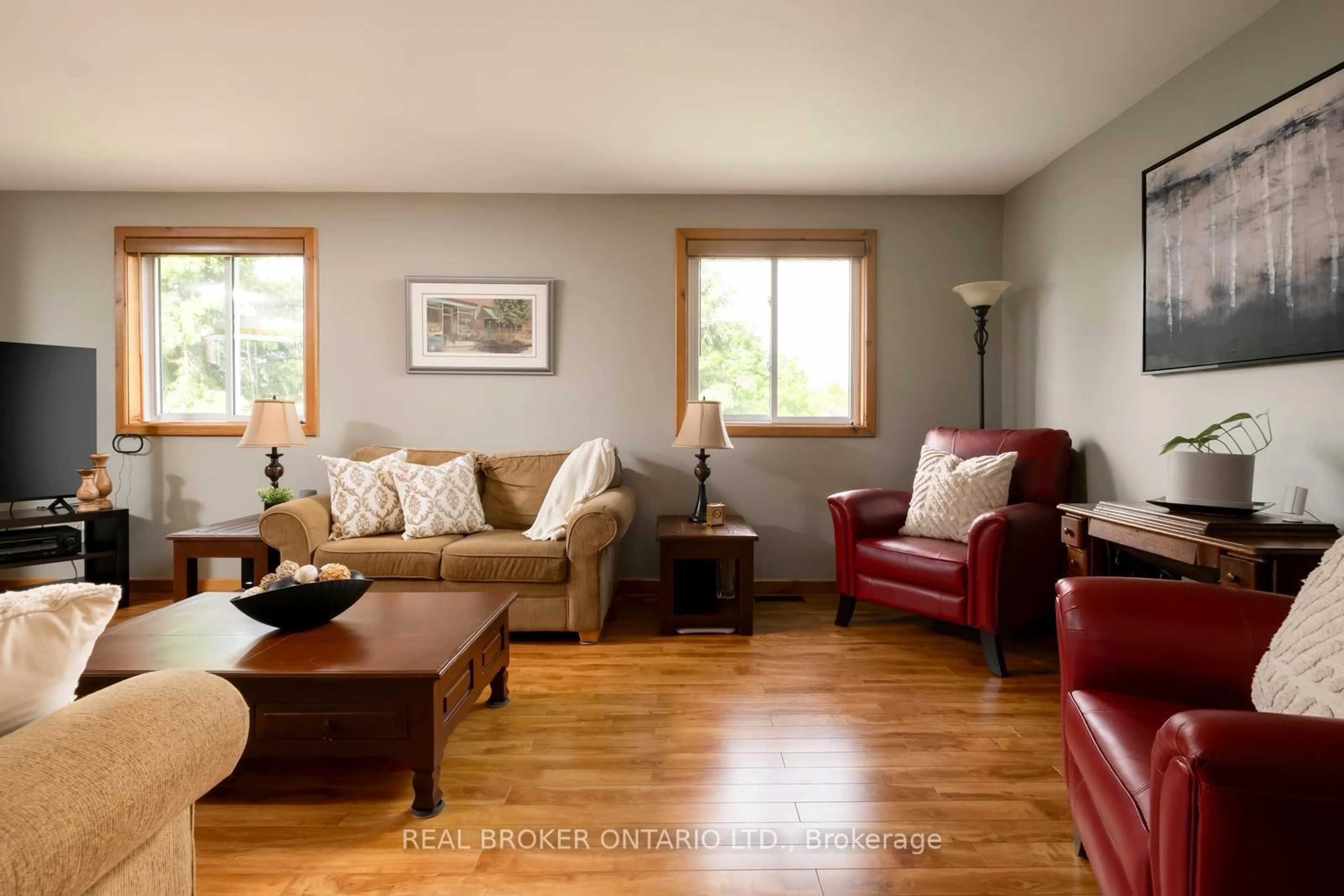Living room with furniture, wood/laminate floor for 1743 Barton Dr, Selwyn Ontario K0L 2H0