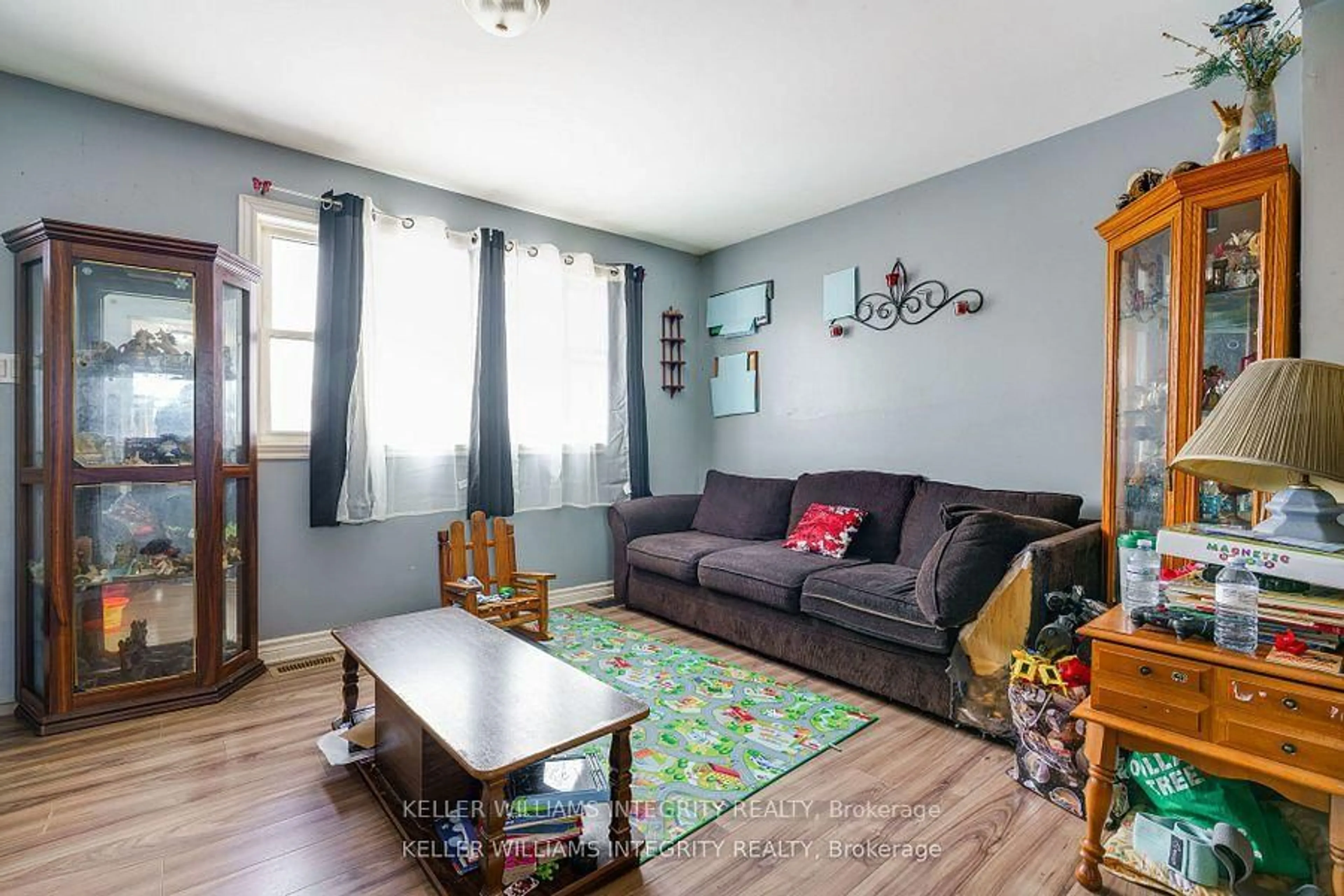 Living room with furniture, wood/laminate floor for 1204-1206 Caswell Cres, Cornwall Ontario K6J 4V6