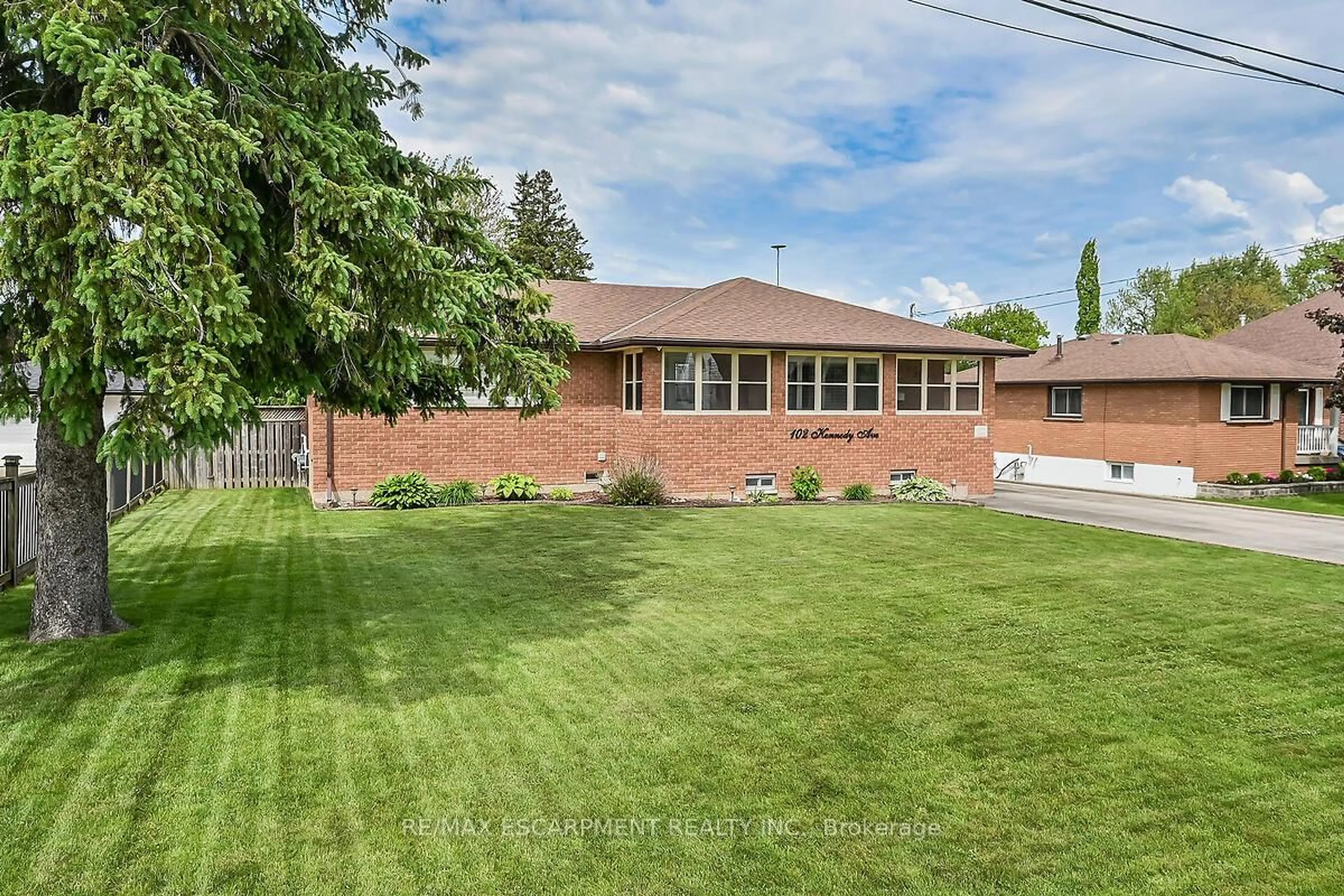 Home with brick exterior material, street for 102 Kennedy Ave, Hamilton Ontario L9B 1C7