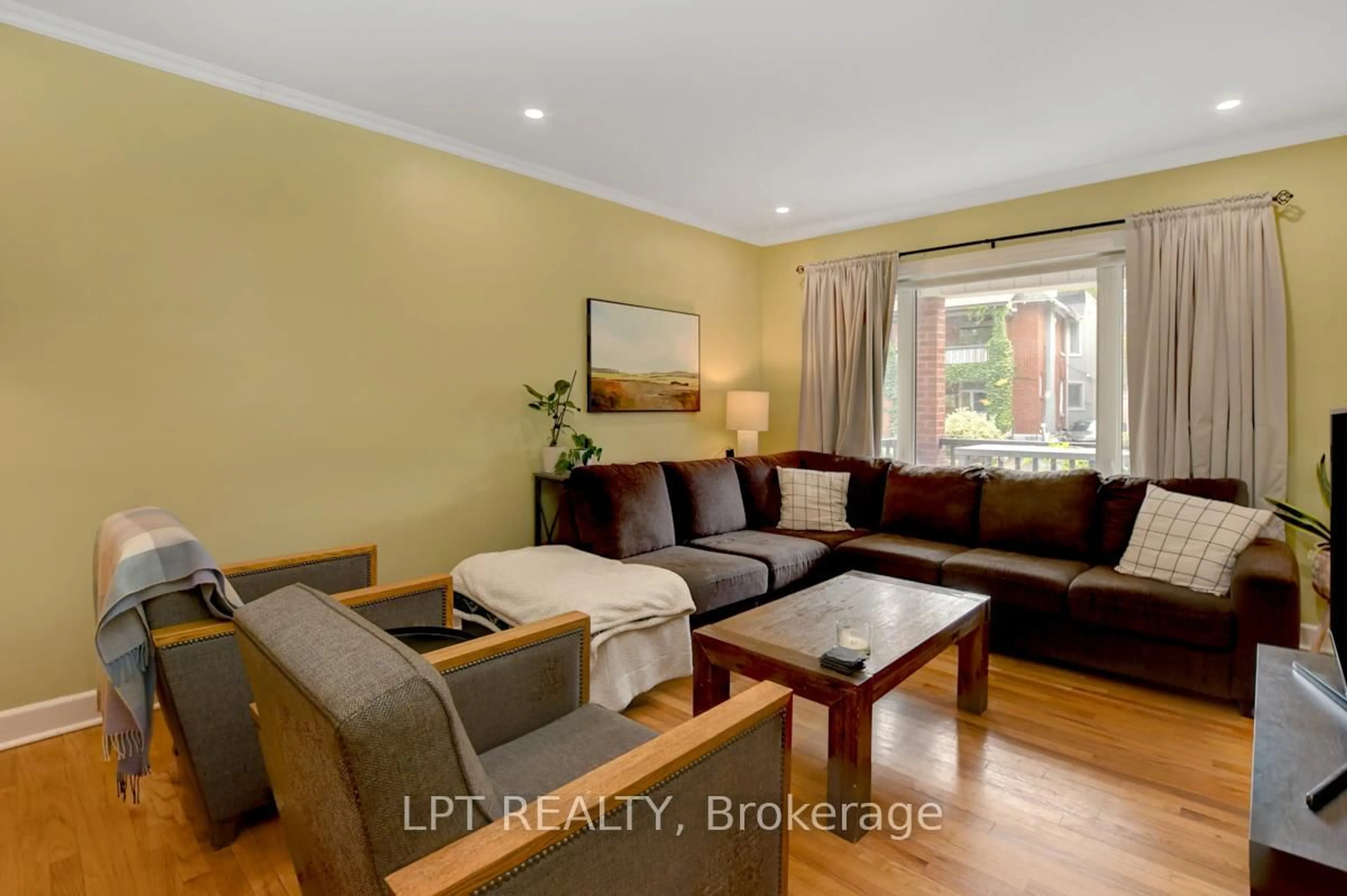 Living room with furniture, wood/laminate floor for 261 Holmwood Ave, Ottawa Ontario K1S 2P8