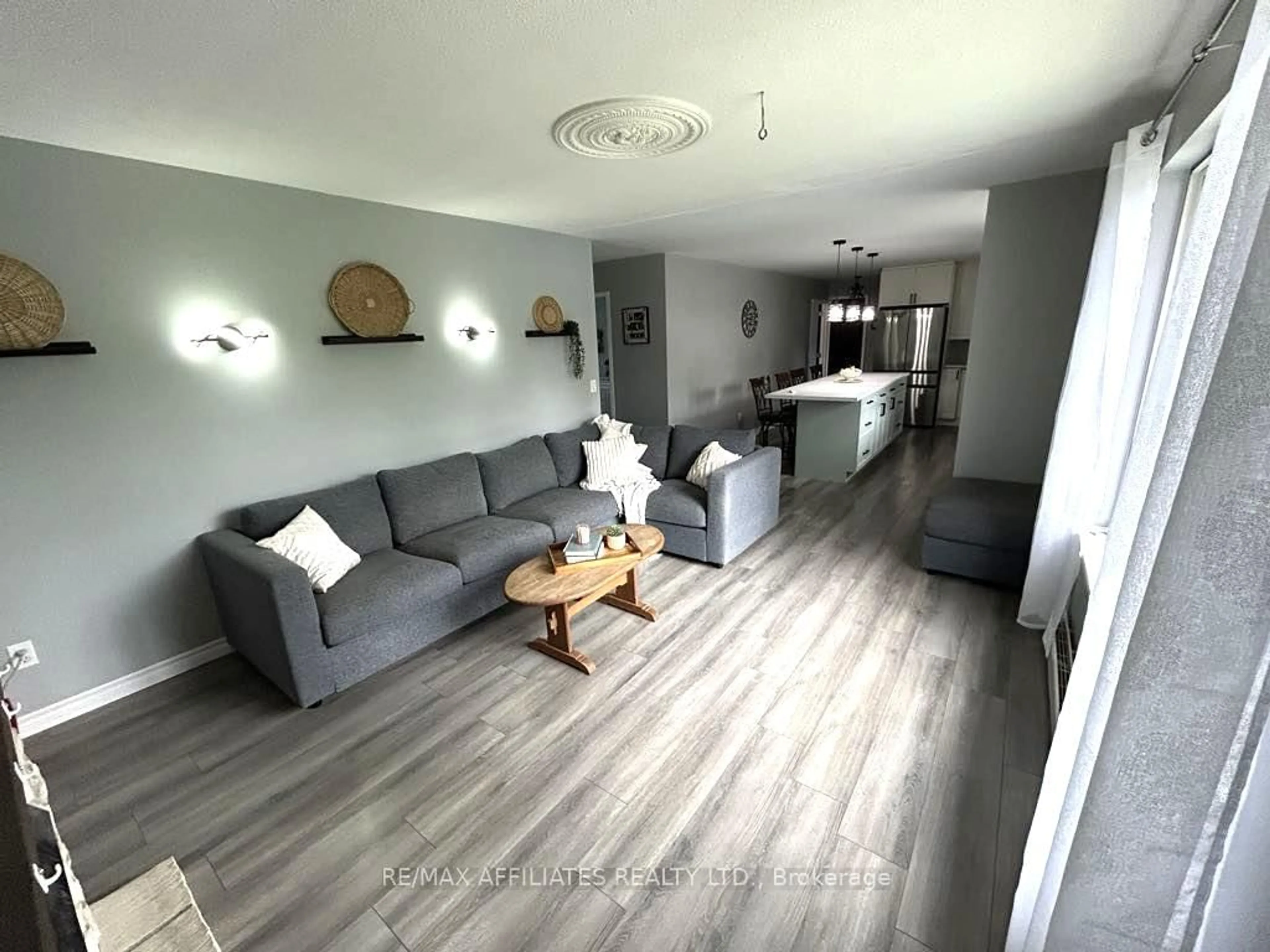 Living room with furniture, wood/laminate floor for 47 Gladstone Ave, Smiths Falls Ontario K7A 1R8