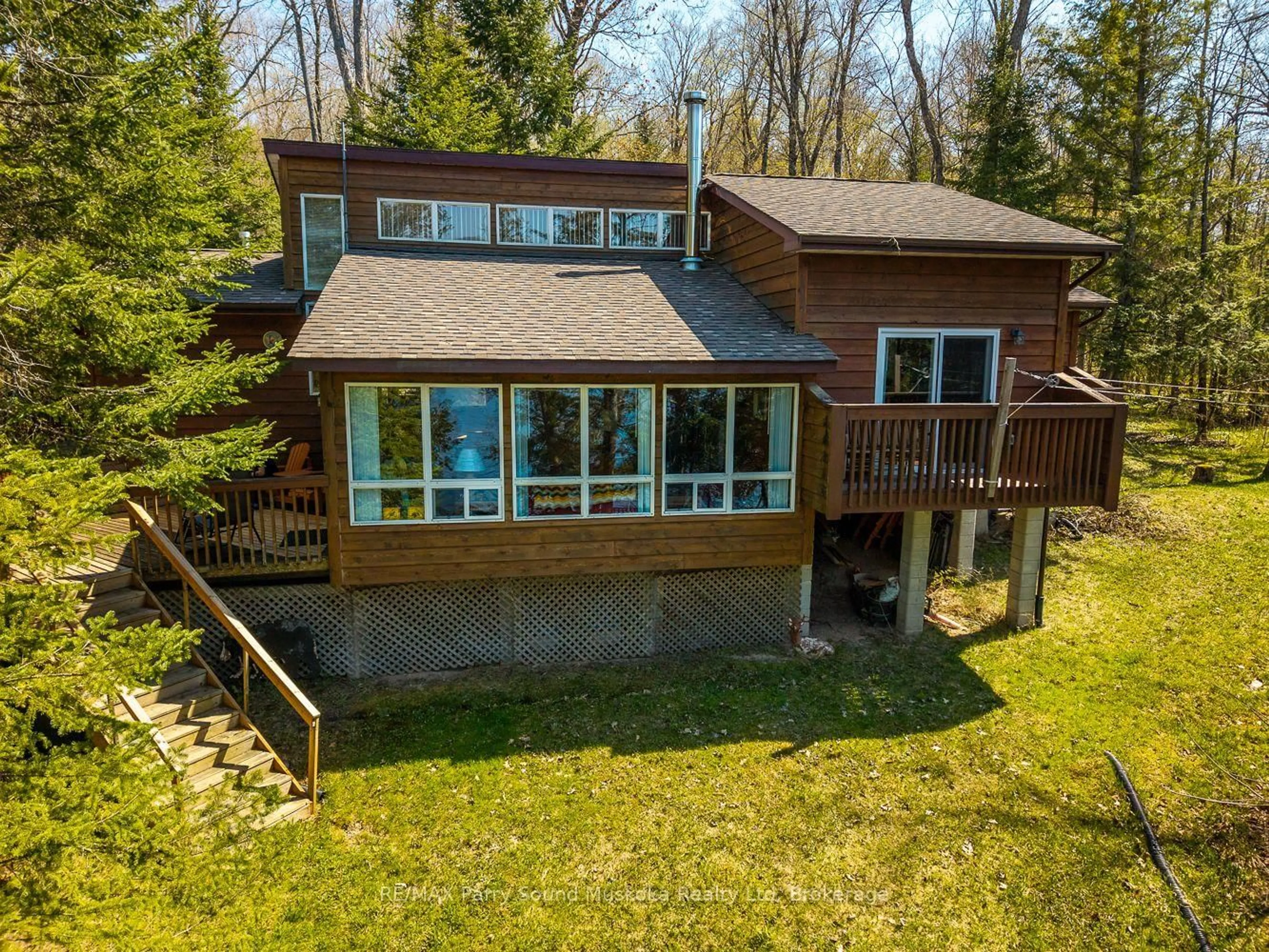 A pic from outside/outdoor area/front of a property/back of a property/a pic from drone, water/lake/river/ocean view for 25 Dancy Lane, McKellar Ontario P2A 0B5
